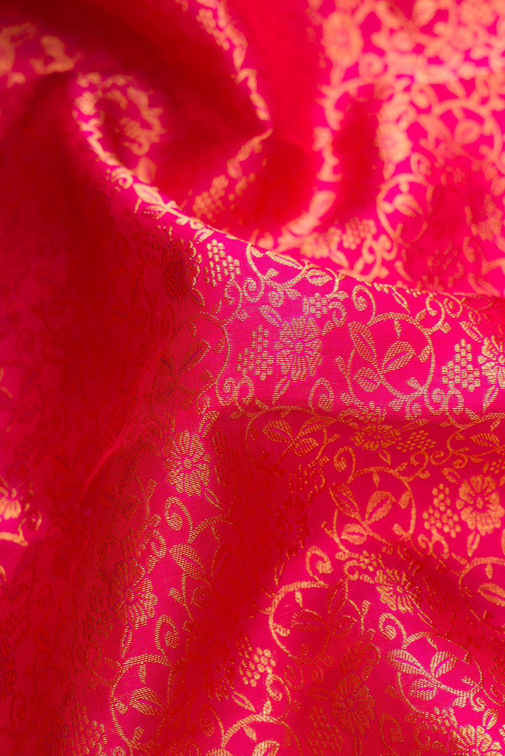 Close up of Dark Pink Dual Tone Kanchipuram Silk Saree with Zari Brocade on the body and Zari Border.  displaying folds