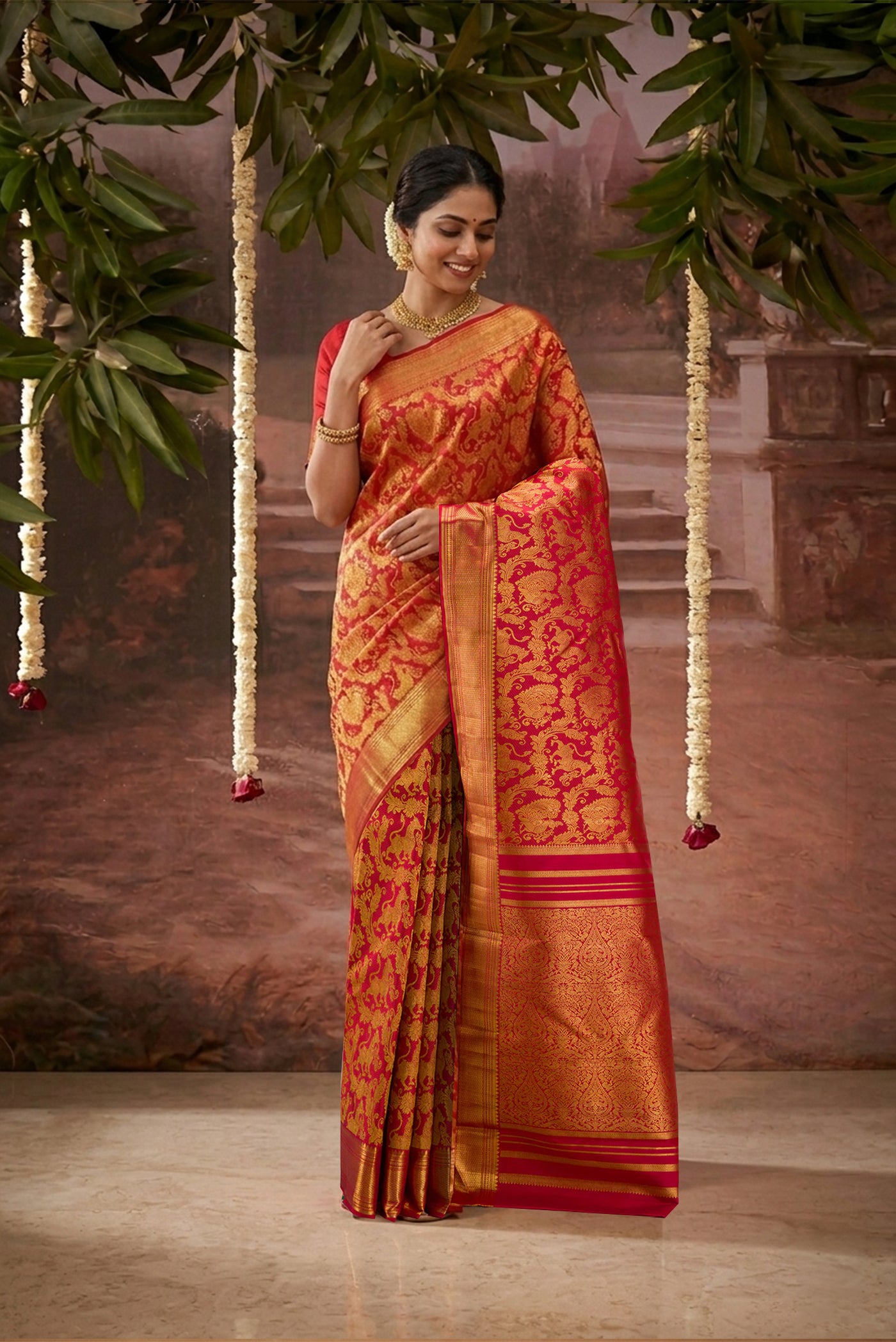 Model wearing a Maroon Kanchipuram Silk Saree with Zari Brocade on the body and Zari Border.