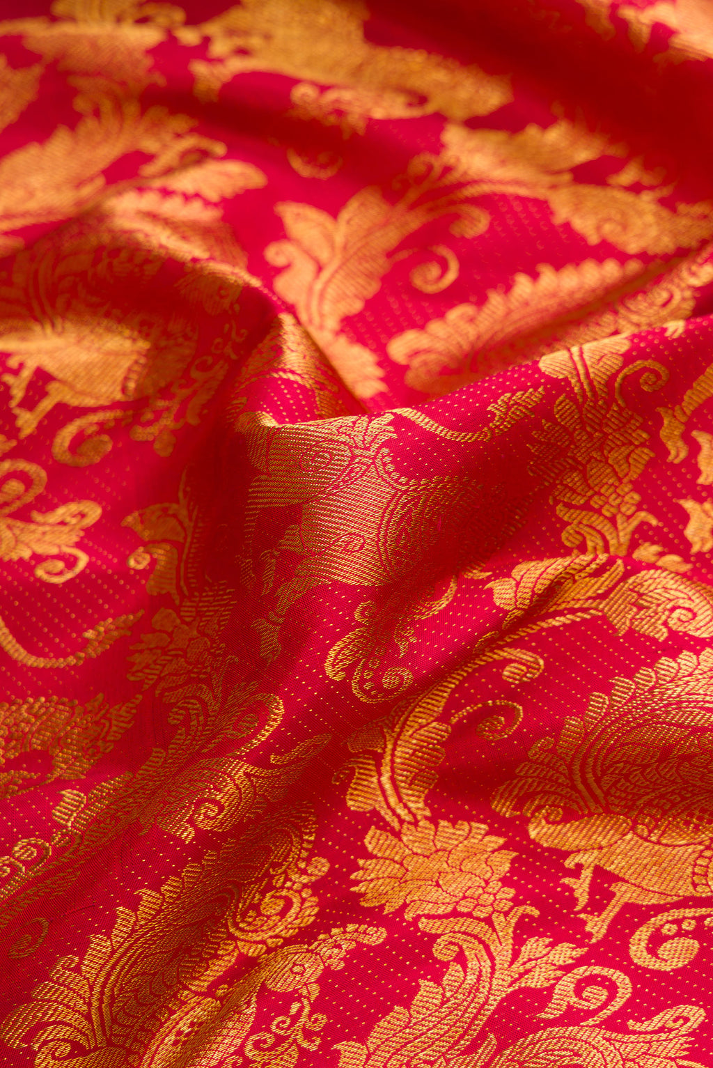 Close up of Maroon Dual Tone Kanchipuram Silk Saree with Zari Brocade on the body and Zari Border.  displaying folds