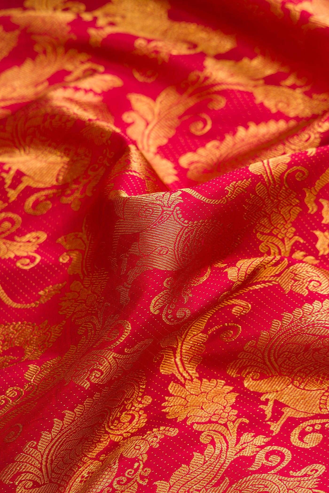 Close up of Maroon Dual Tone Kanchipuram Silk Saree with Zari Brocade on the body and Zari Border.  displaying folds