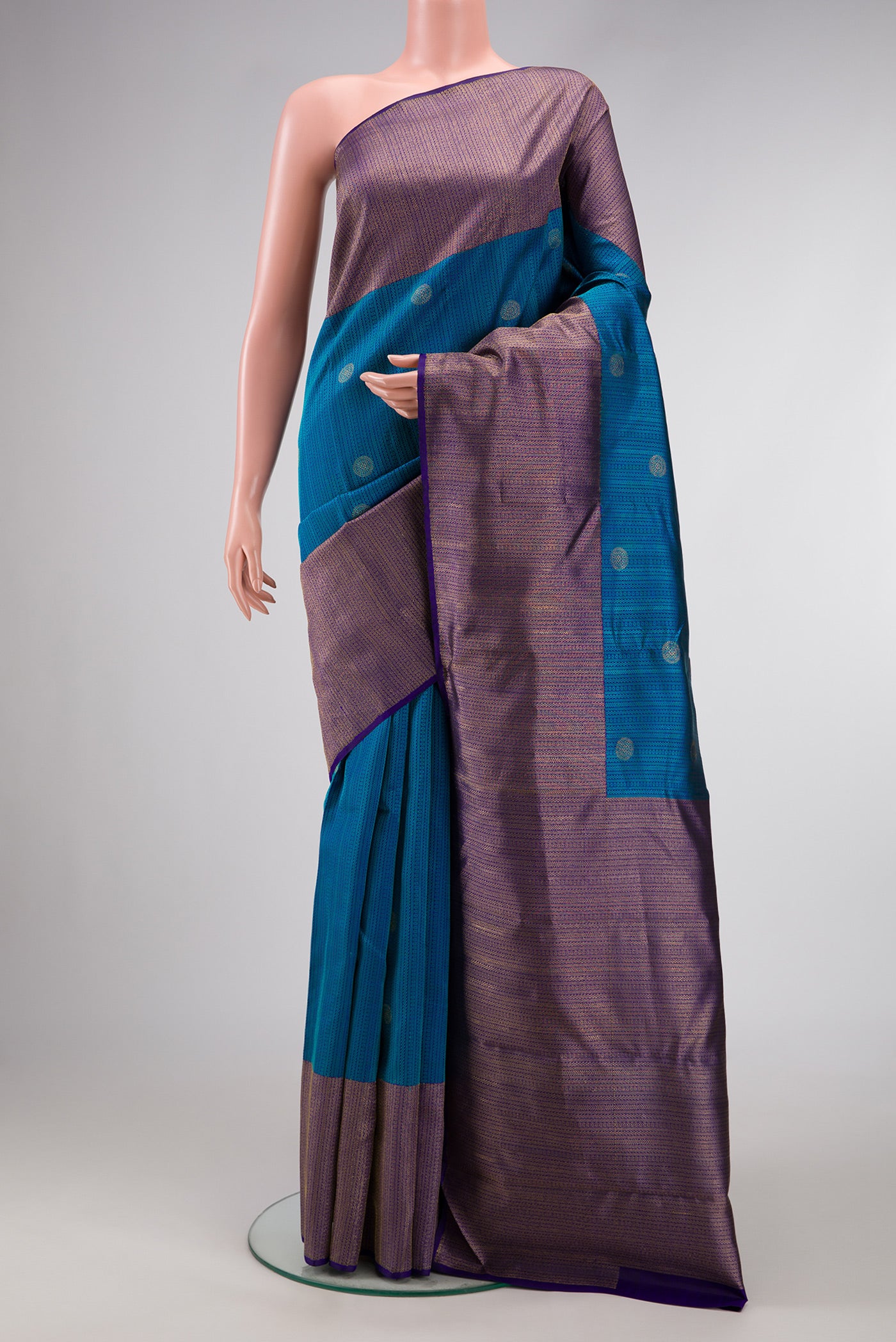 Peacock Blue Dual Tone Kanchipuram Silk Saree with Jacquard With Zari Butta on the body and Zari Border.  displayed on a mannequin