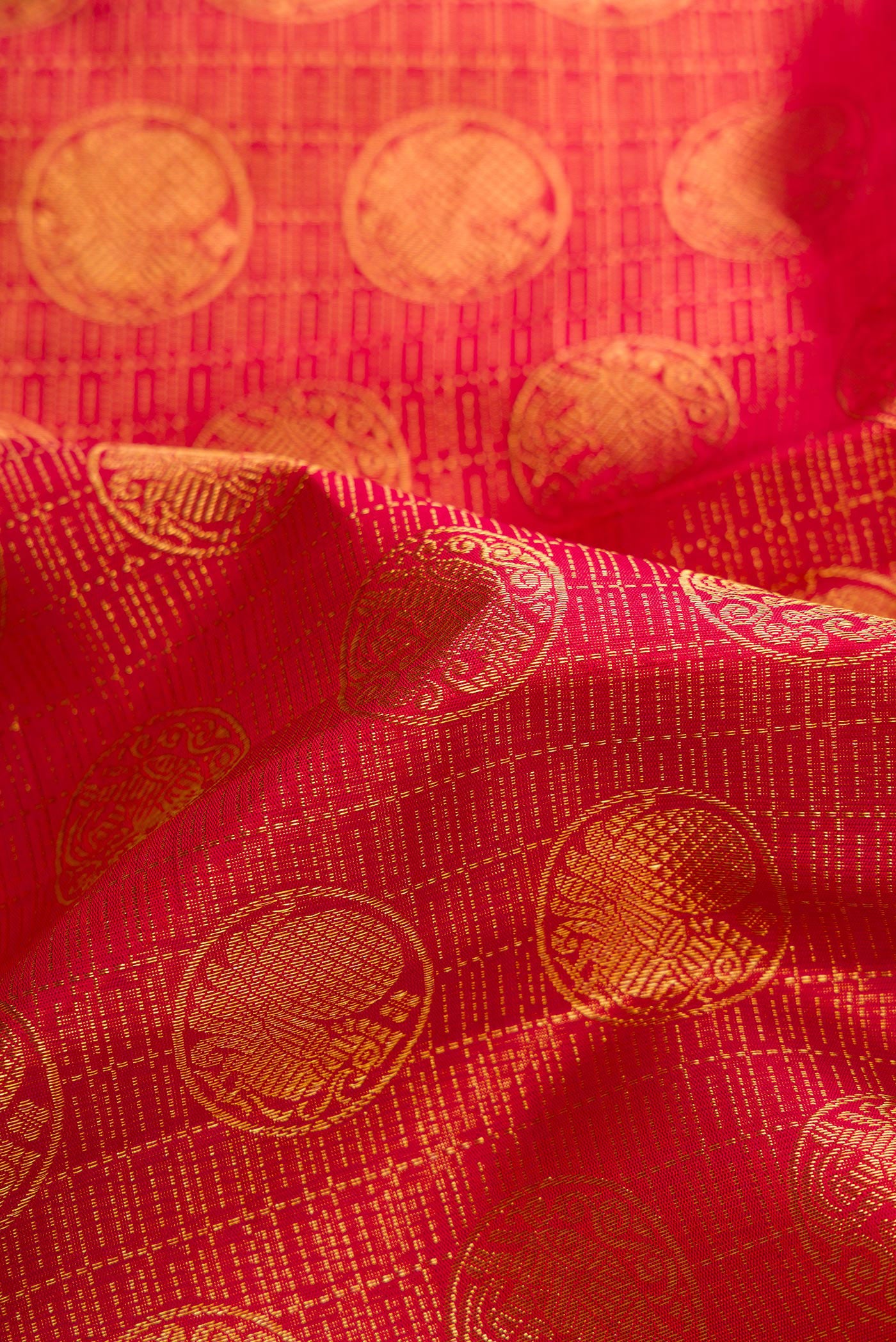 Close up of Maroon Dual Tone Kanchipuram Silk Saree with Zari Brocade on the body and Zari Border.  displaying folds