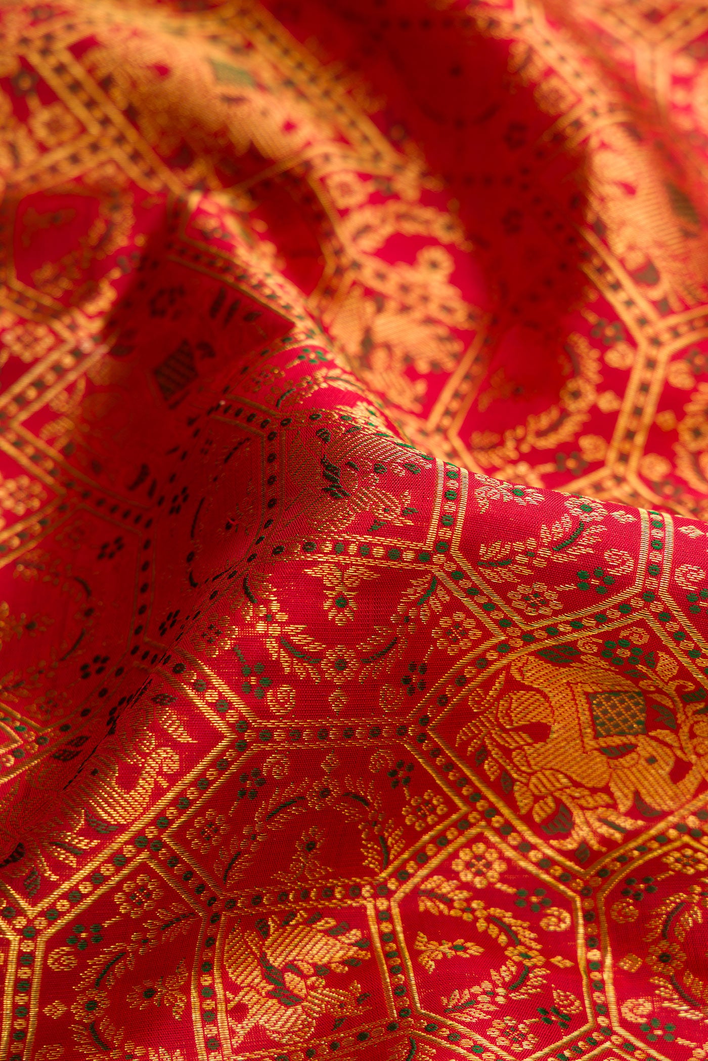 Close up of Red Dual Tone Kanchipuram Silk Saree with Zari Brocade on the body and Zari Border.  displaying folds