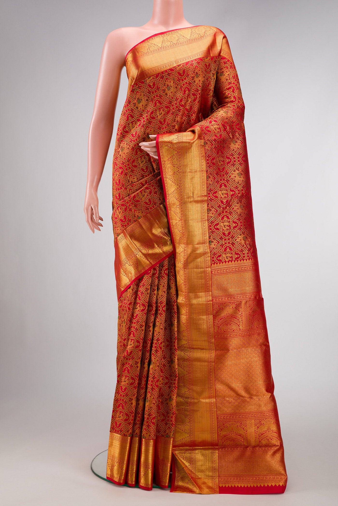 Red Dual Tone Kanchipuram Silk Saree with Zari Brocade on the body and Zari Border.  displayed on a mannequin
