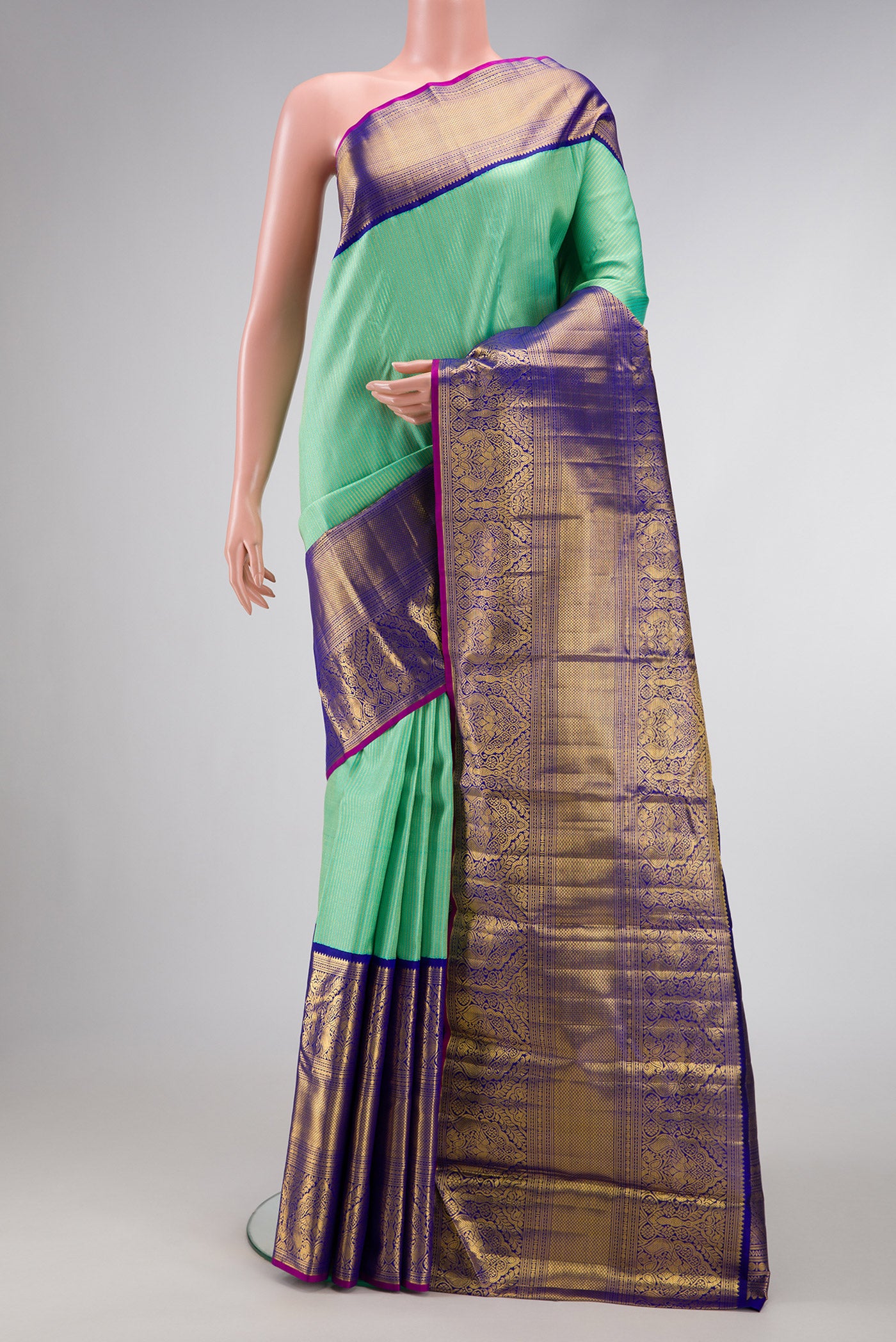 Pista Green Dual Tone Kanchipuram Silk Saree with Zari Brocade on the body and Zari Border.  displayed on a mannequin