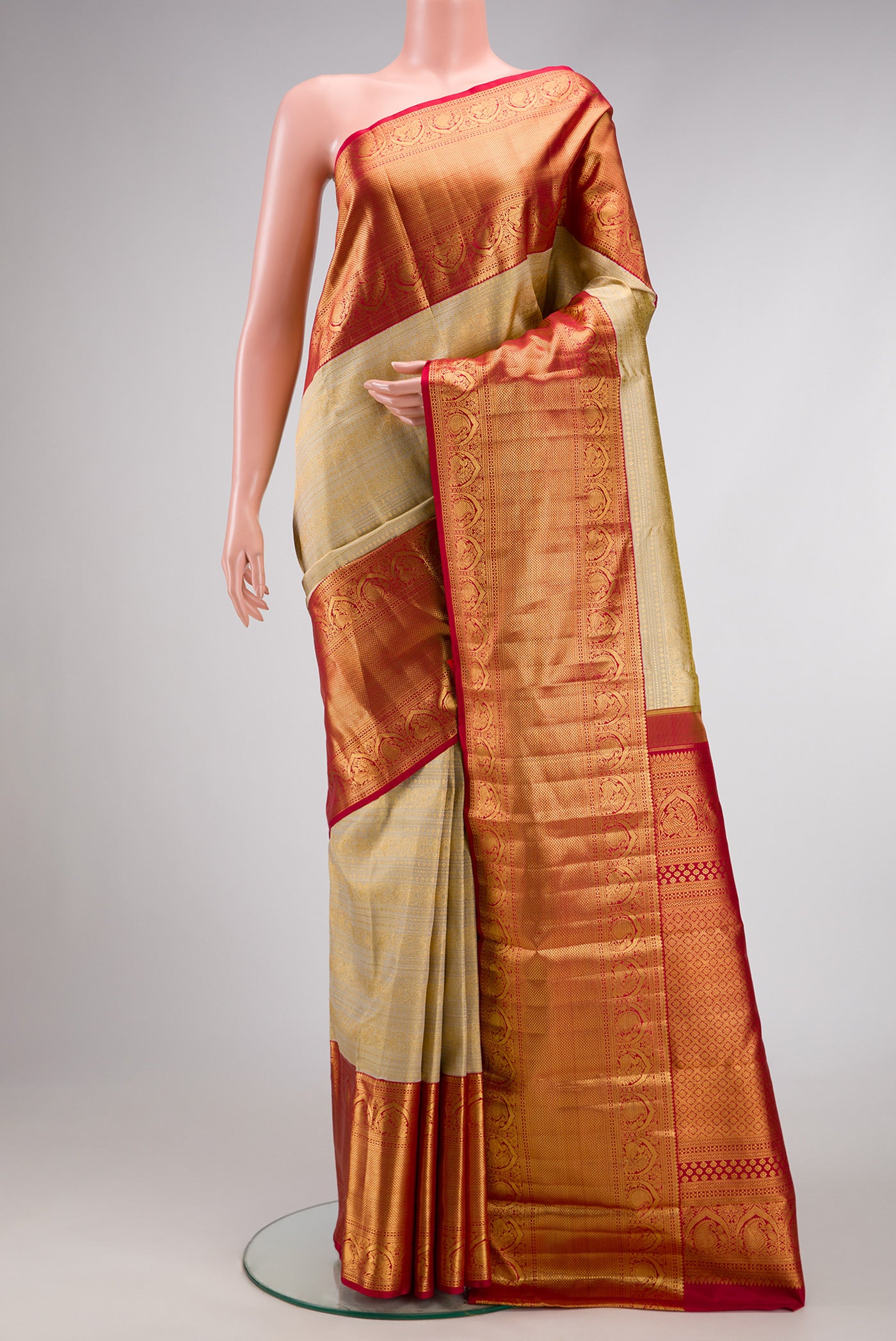 Beige Dual Tone Kanchipuram Silk Saree with Zari Brocade on the body and Zari Border.  displayed on a mannequin