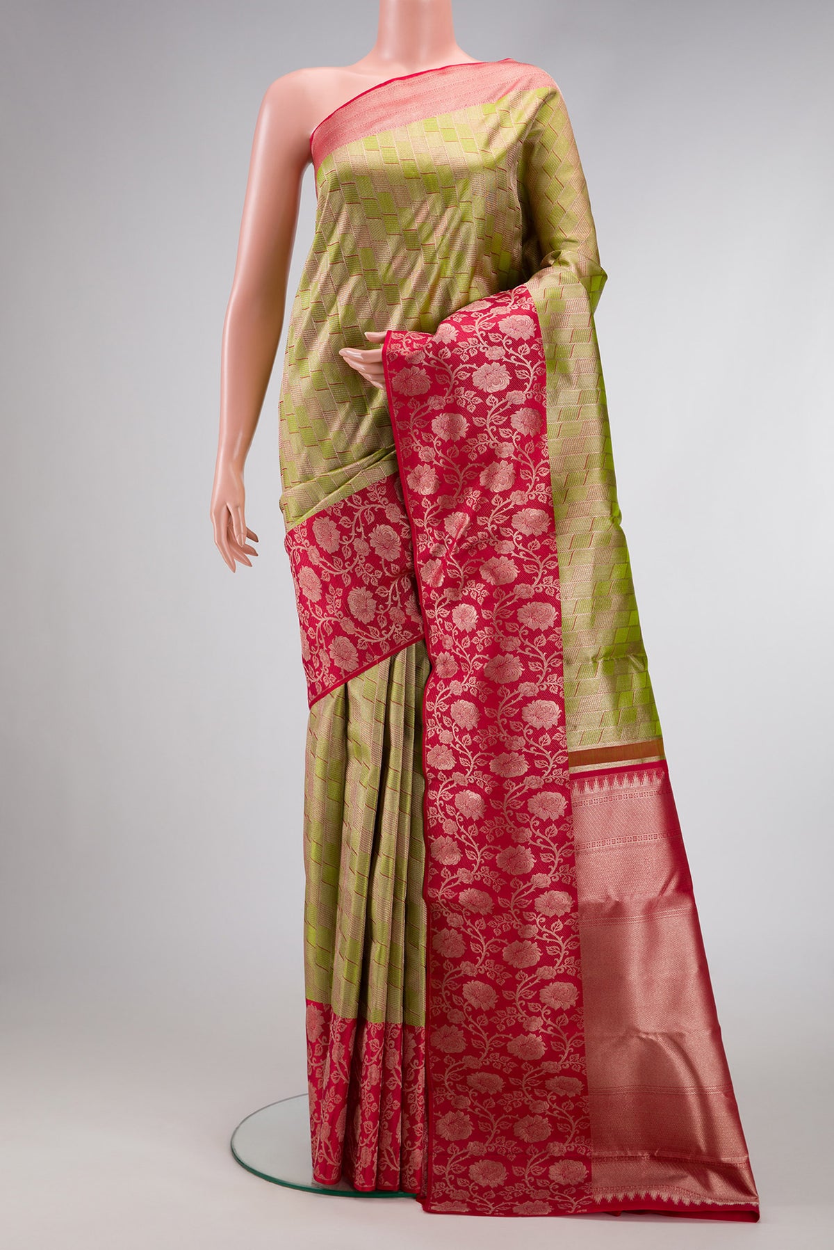 Parrot Green Dual Tone Kanjivaram Tissue Silk Saree with Zari Brocade on the body and Fancy Border.  displayed on a mannequin