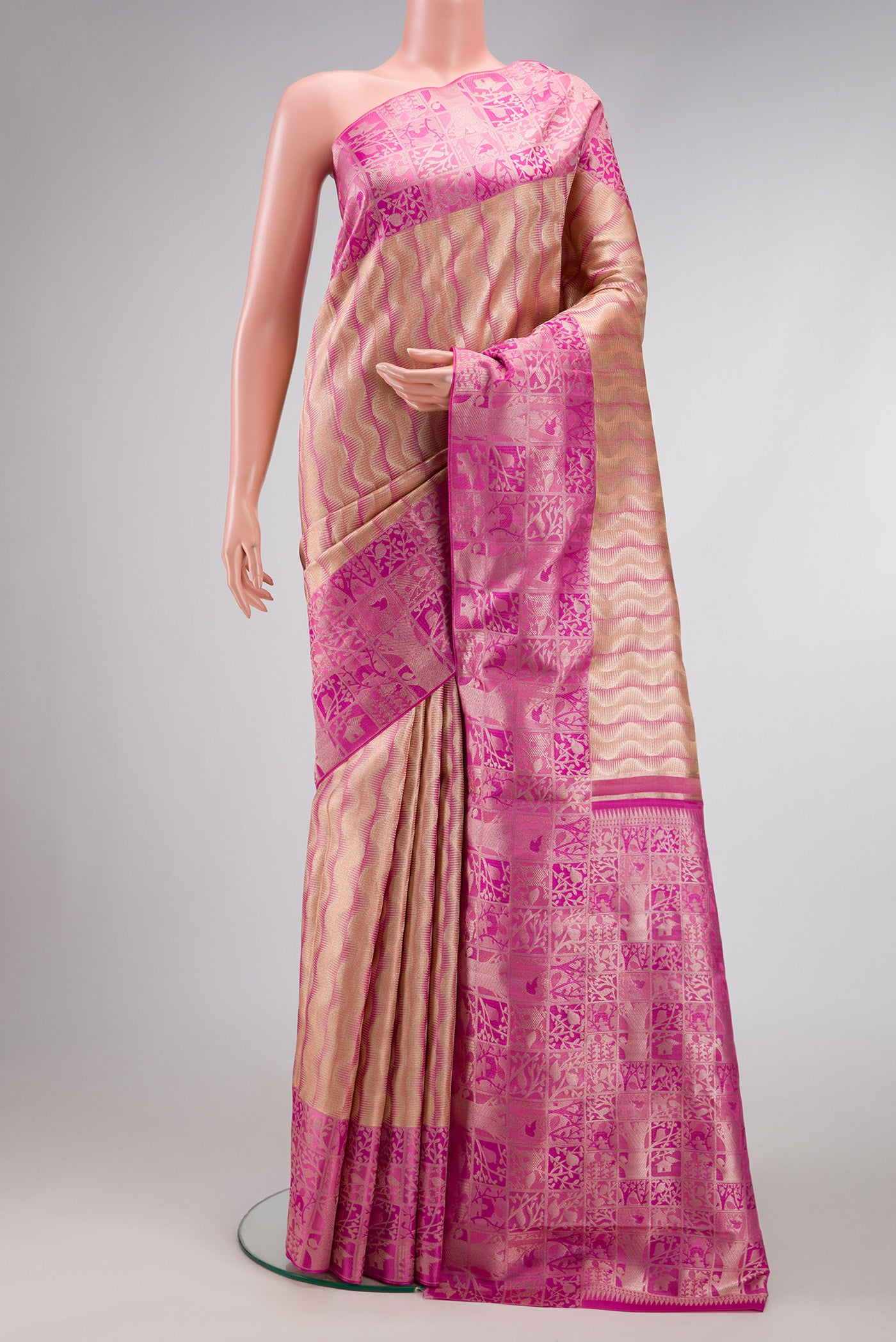 Golden Peach Dual Tone Kanjivaram Tissue Silk Saree with Zari Brocade on the body and Zari Border.  displayed on a mannequin