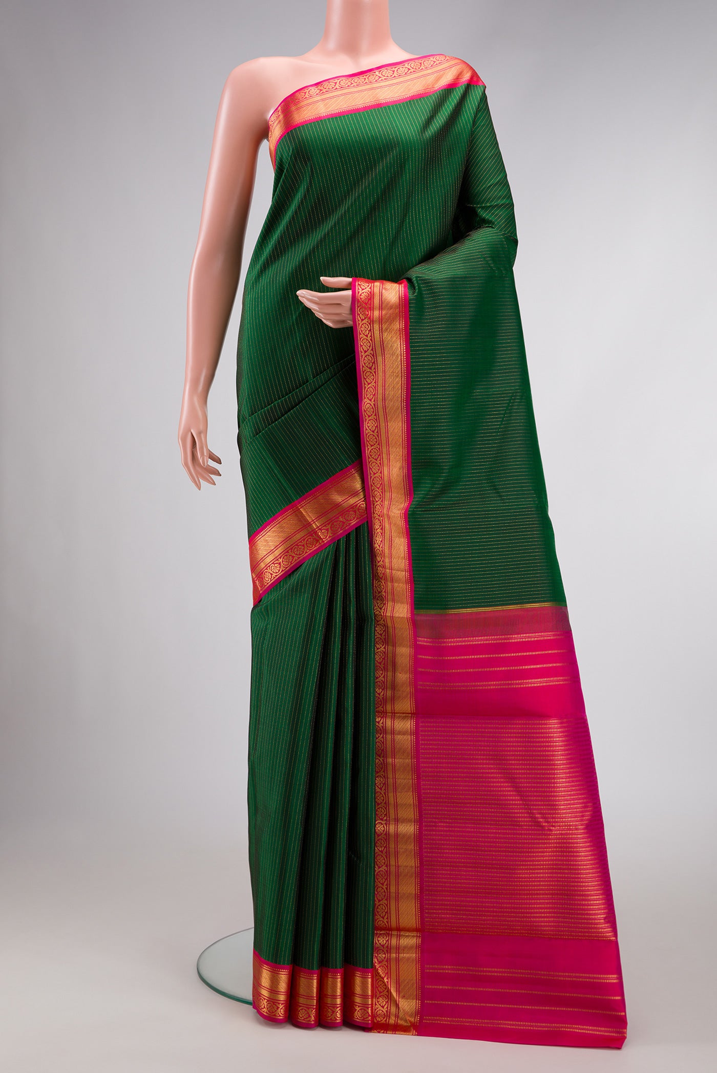 Green Dual Tone Kanjivaram Silk Saree with Stripes on the body and Zari Border.  displayed on a mannequin