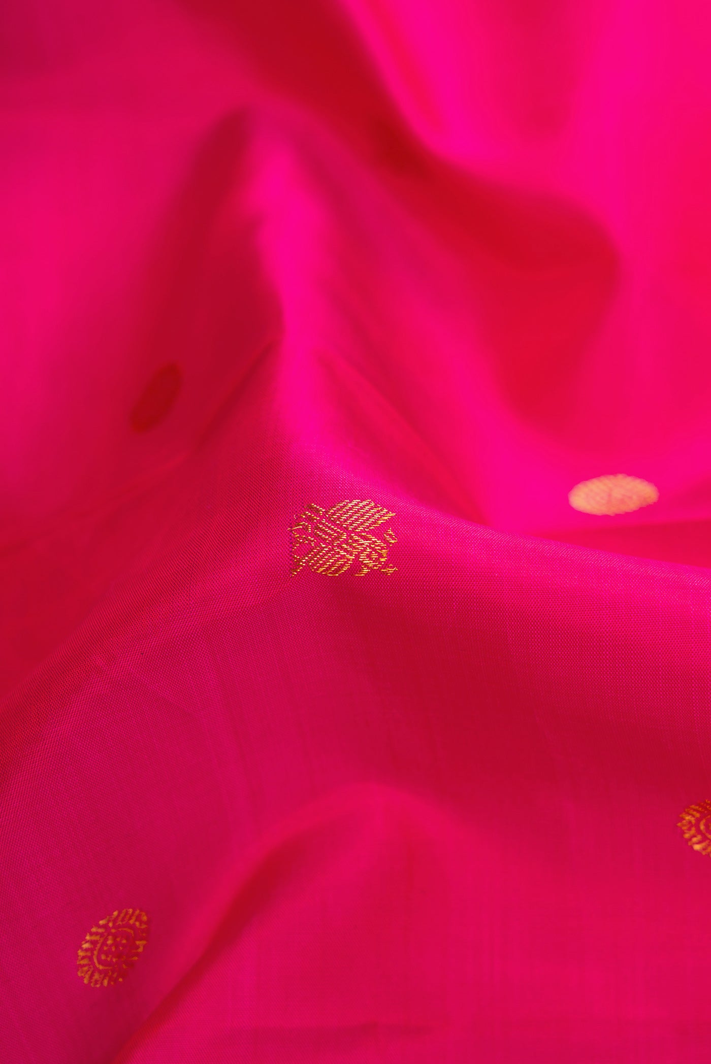 Close up of Pink Dual Tone Kanchipuram Silk Saree with Zari Butta on the body and Zari Border.  displaying folds