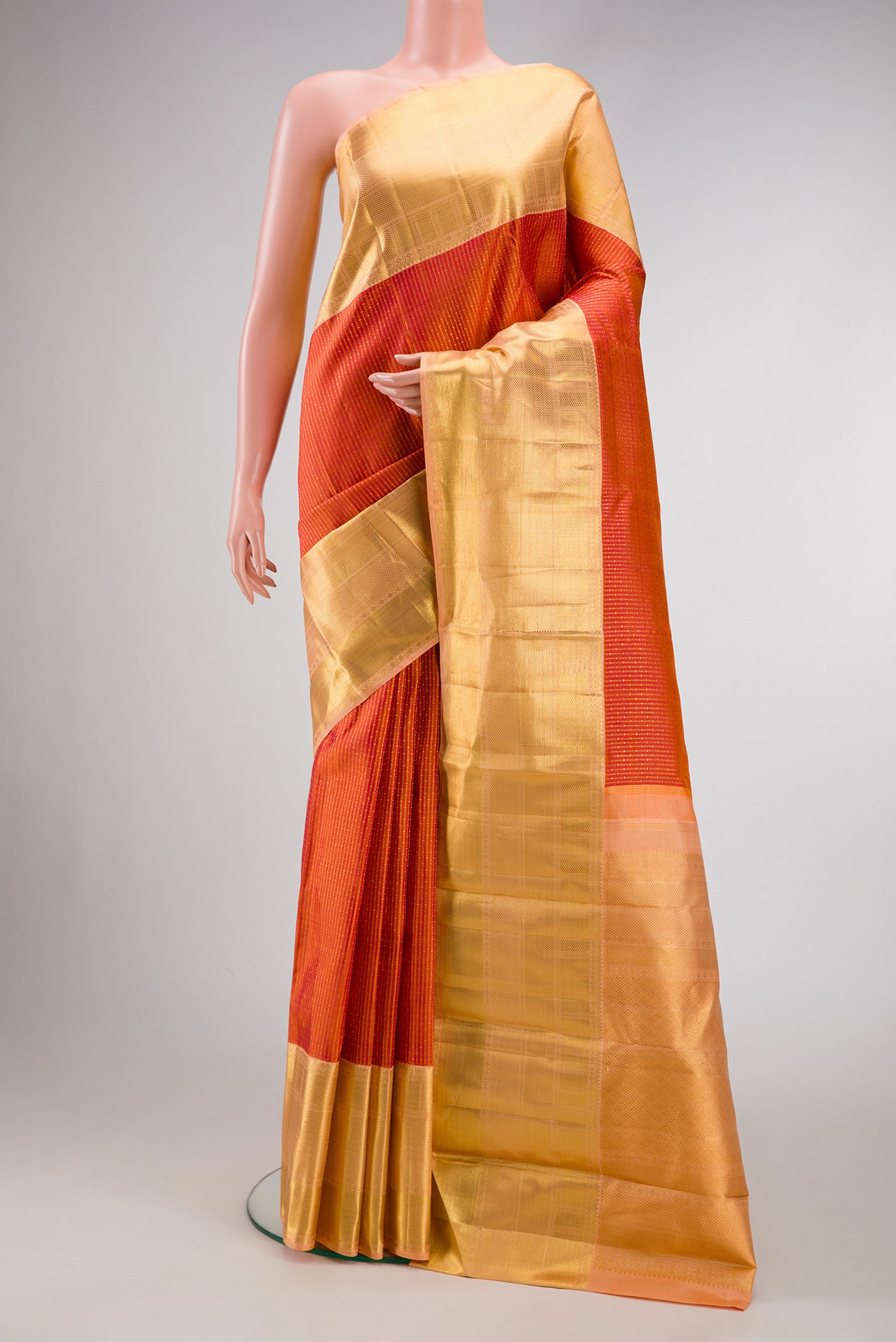 Brick Orange Dual Tone Kanchipuram Silk Saree with Zari Brocade on the body and Zari Border.  displayed on a mannequin