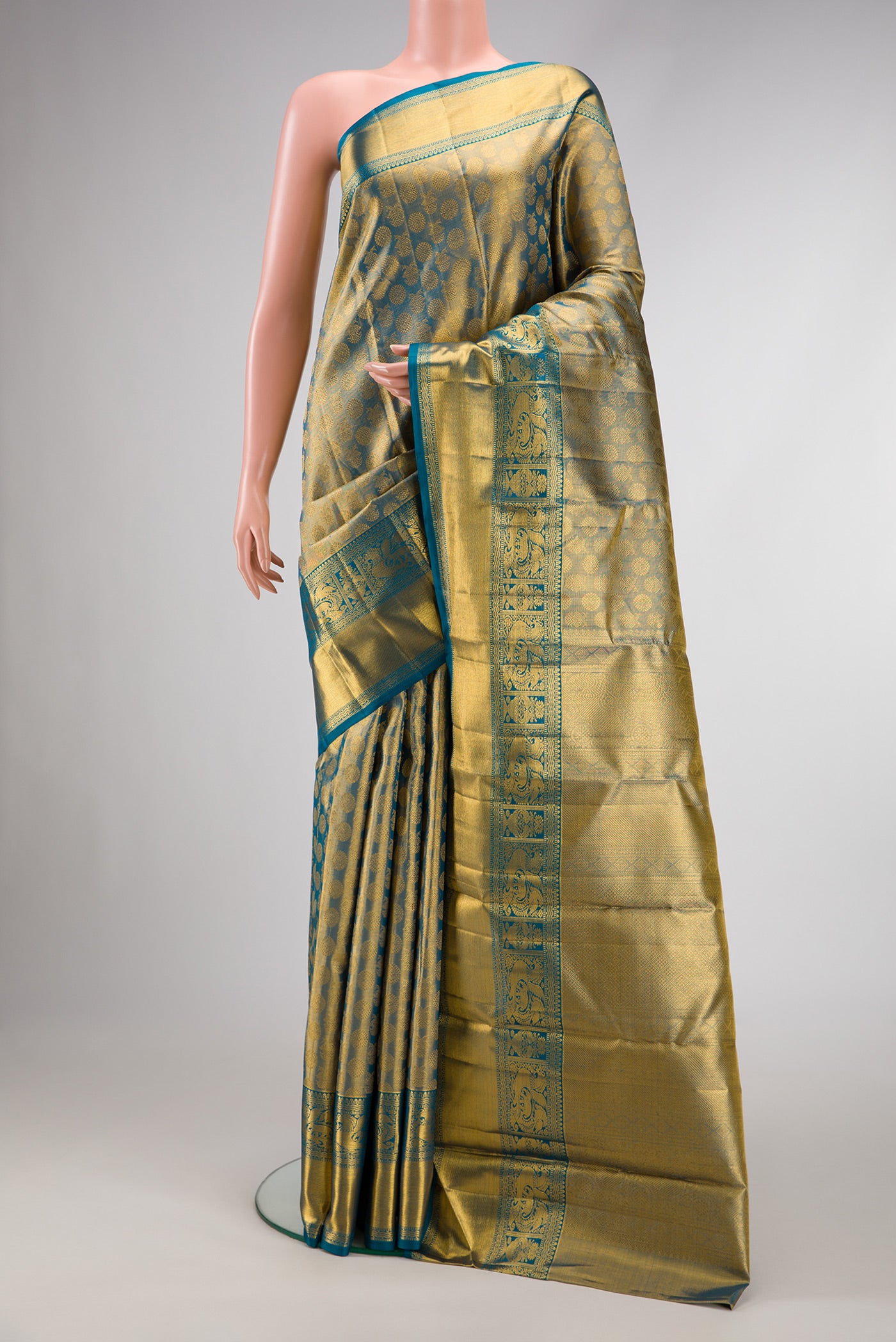 Maya Blue Dual Tone Kanchipuram Tissue Silk Saree with Zari Brocade on the body and Zari Border.  displayed on a mannequin