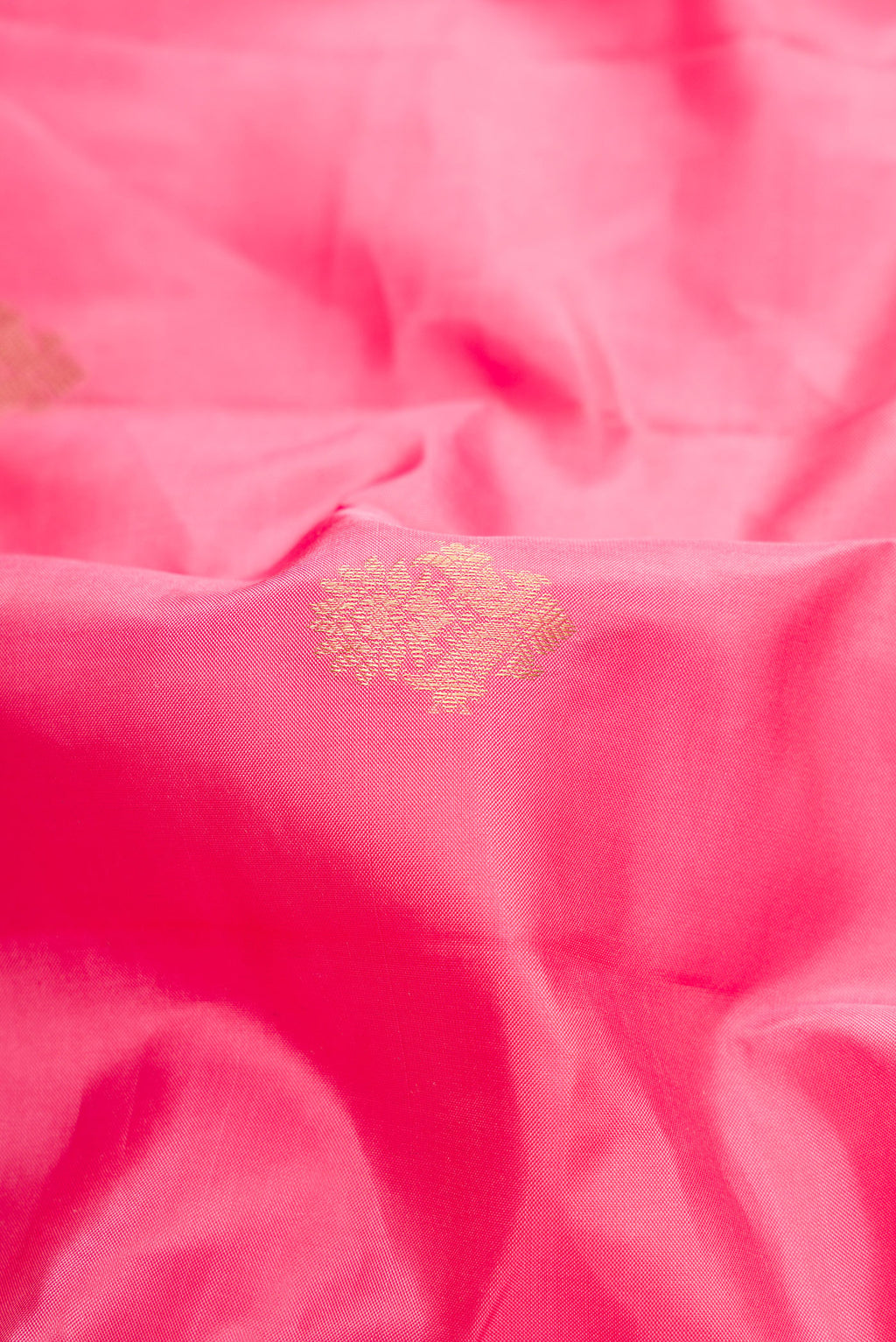 Close up of Pink Dual Tone Kanchipuram Silk Saree with Zari Butta on the body and Zari Border.  displaying folds