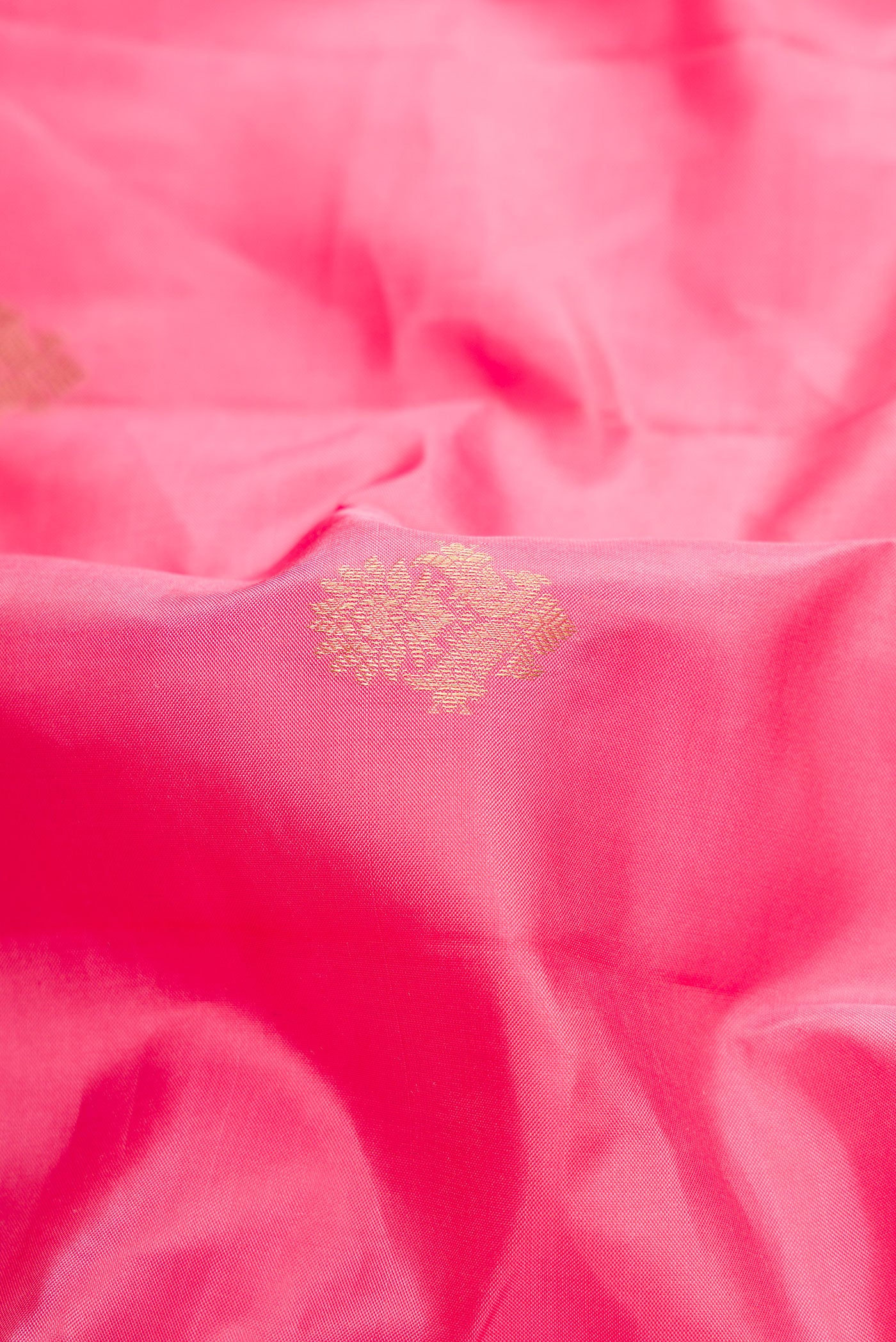 Close up of Pink Dual Tone Kanchipuram Silk Saree with Zari Butta on the body and Zari Border.  displaying folds