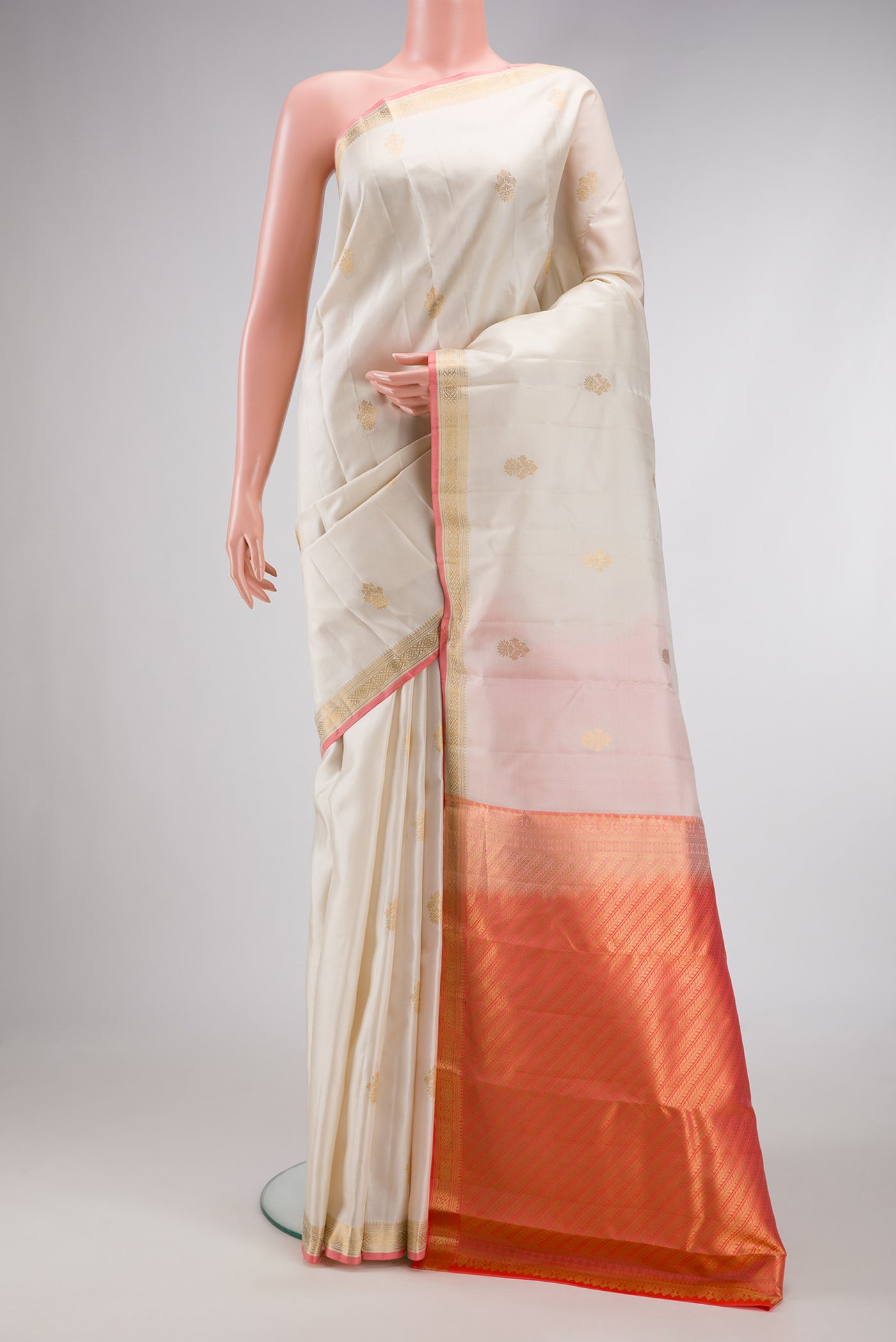 Off White Dual Tone Kanchipuram Silk Saree with Zari Butta on the body and Zari Border.  displayed on a mannequin
