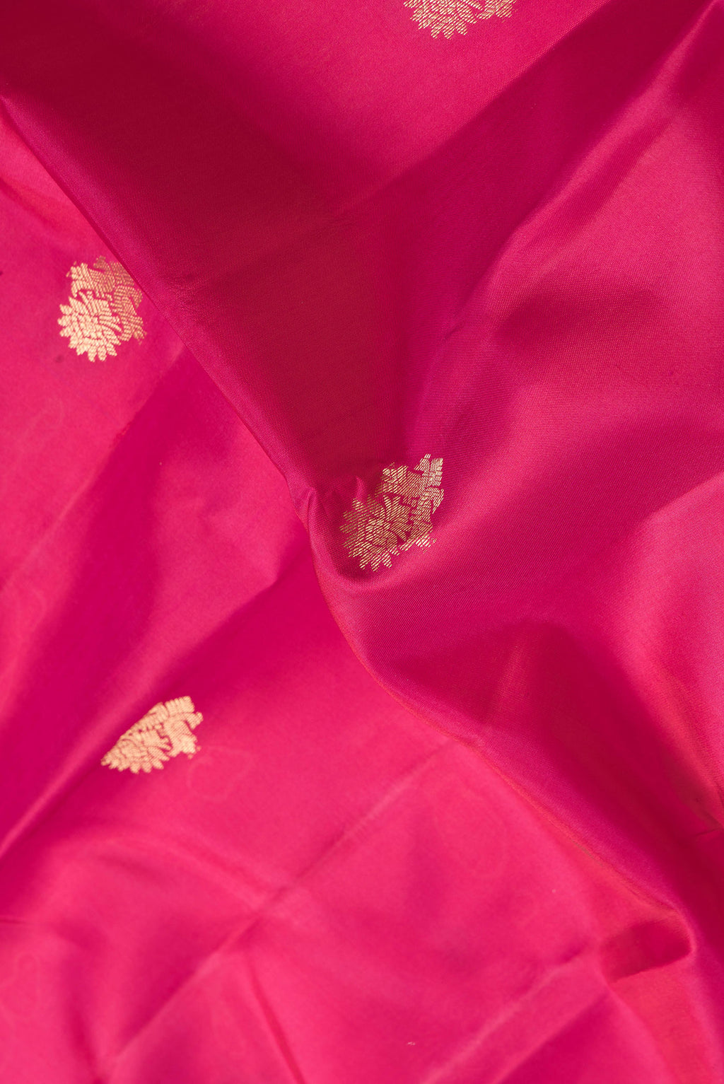 Close up of Pink Dual Tone Kanchipuram Silk Saree with Zari Butta on the body and Zari Border.  displaying folds