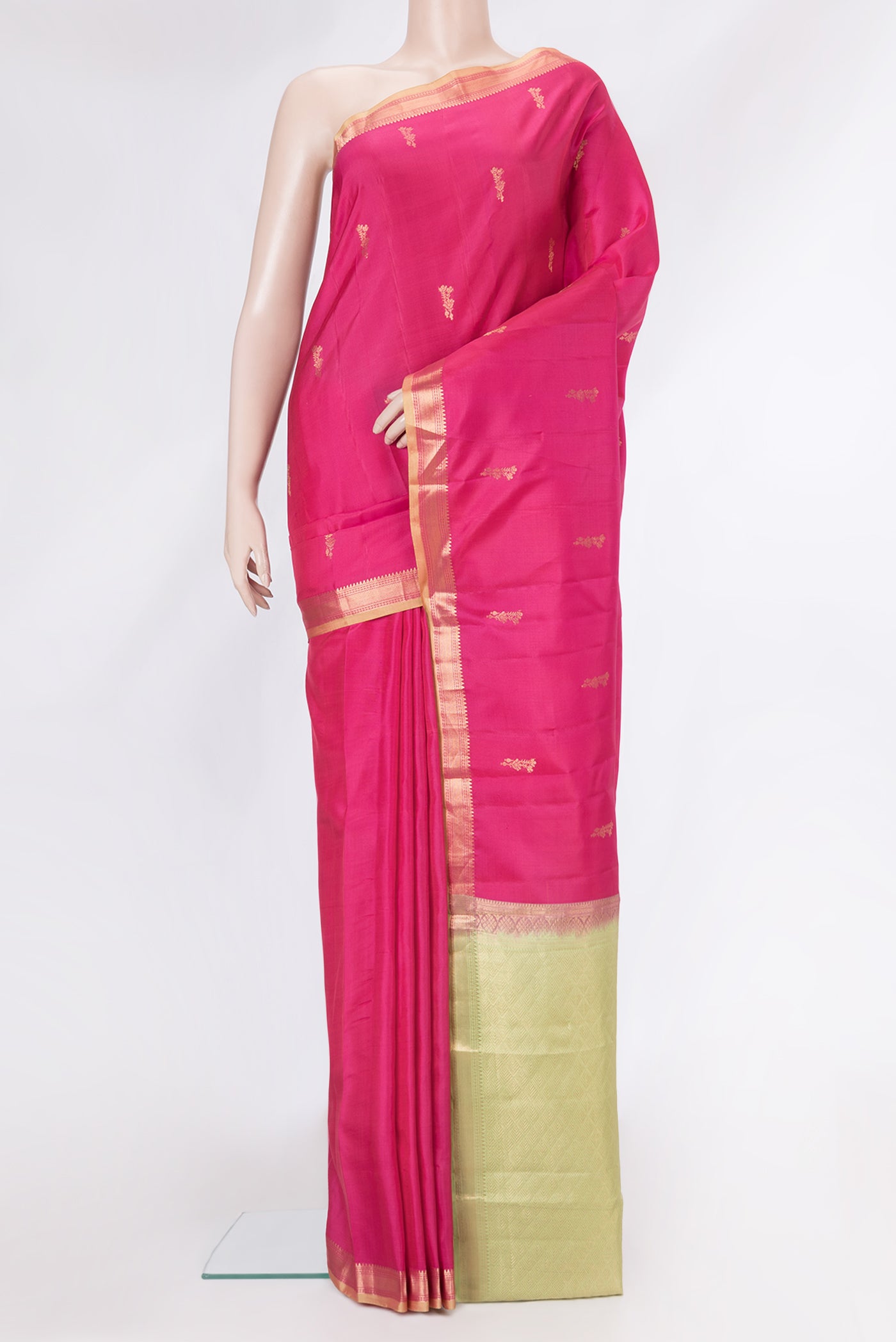 Pink Kanchipuram Silk Saree with Zari Butta on the body and Zari Border.  displayed on a mannequin