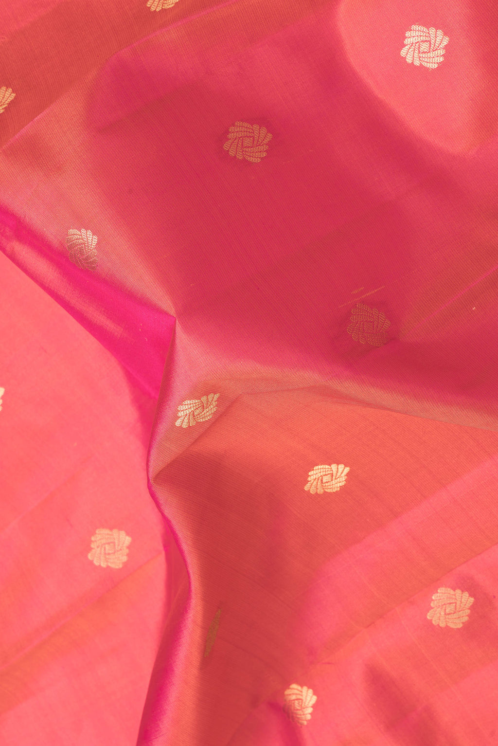 Close up of Pink Dual Tone Kanchipuram Silk Saree with Zari Butta on the body and Zari Border.  displaying folds