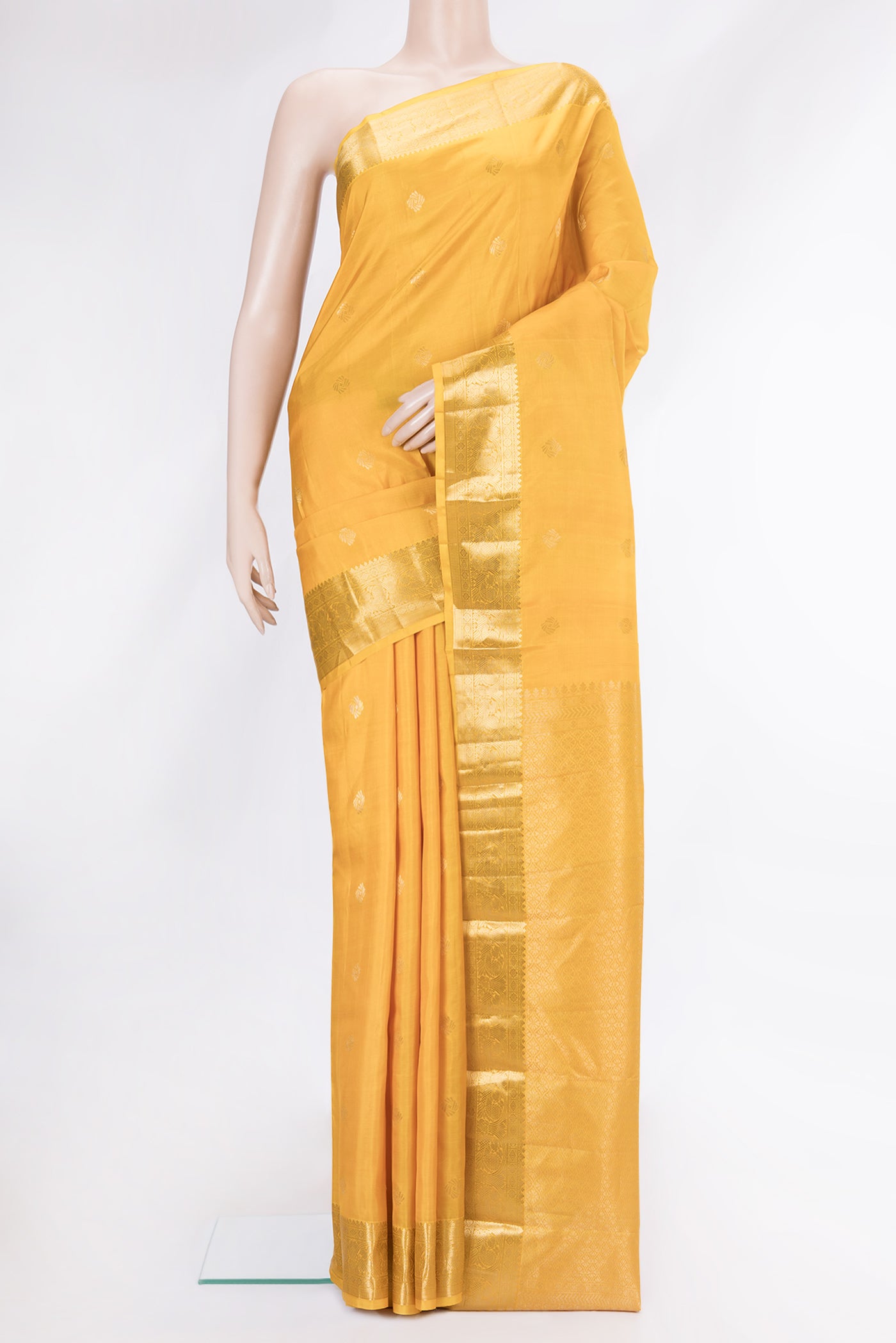 Mustard Dual Tone Kanchipuram Silk Saree with Zari Butta on the body and Zari Border.  displayed on a mannequin