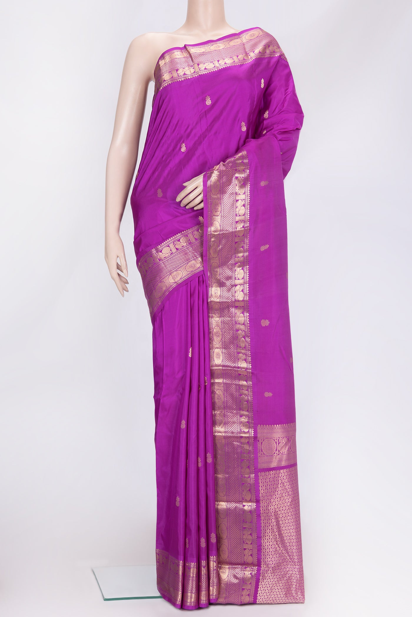 Magenta Dual Tone Kanchipuram Silk Saree with Zari Butta on the body and Zari Border.  displayed on a mannequin