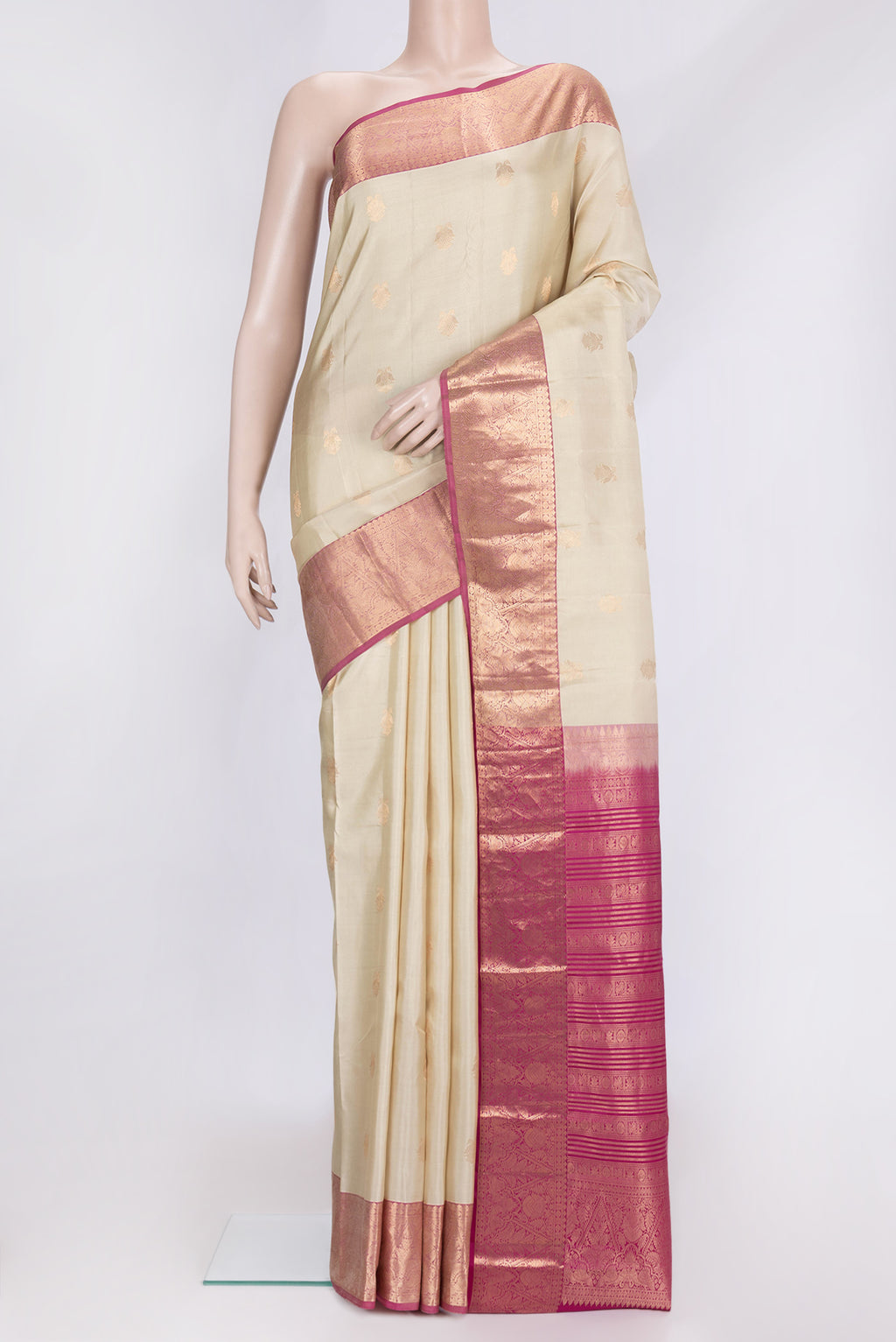Beige Dual Tone Kanchipuram Silk Saree with Zari Butta on the body and Zari Border.  displayed on a mannequin