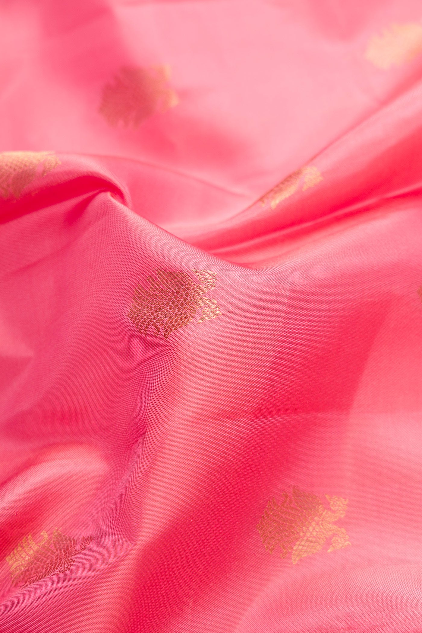 Close up of Pink Dual Tone Kanchipuram Silk Saree with Zari Butta on the body and Zari Border.  displaying folds