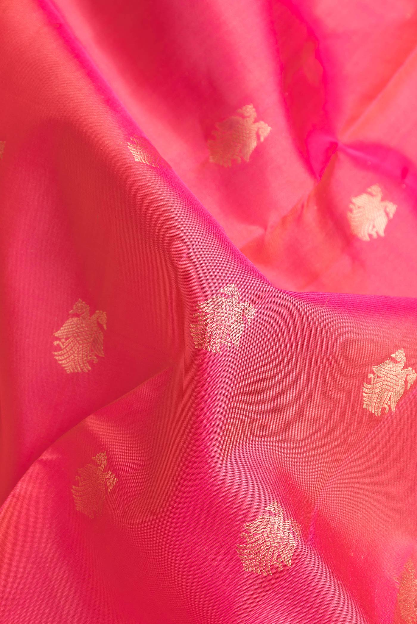 Close up of Pink Dual Tone Kanchipuram Silk Saree with Zari Butta on the body and Zari Border.  displaying folds