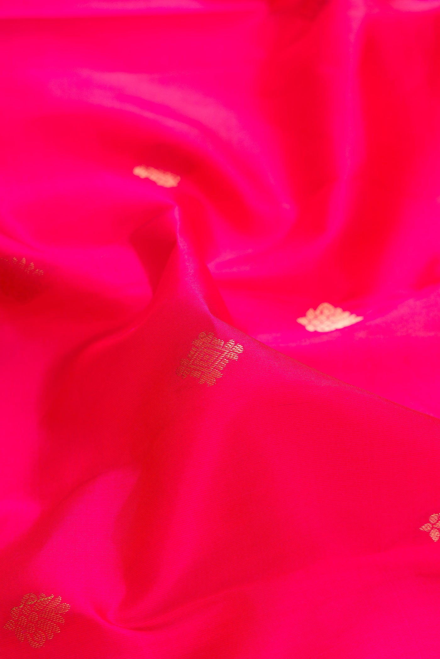Close up of Pink Dual Tone Kanchipuram Silk Saree with Zari Butta on the body and Zari Border.  displaying folds