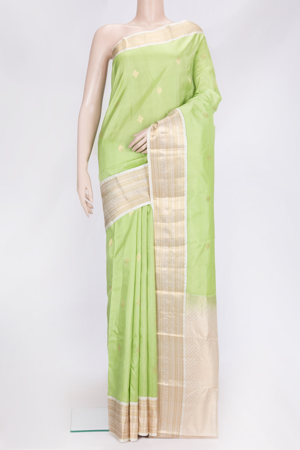 Pista Green Dual Tone Kanchipuram Silk Saree with Zari Butta on the body and Zari Border.  displayed on a mannequin