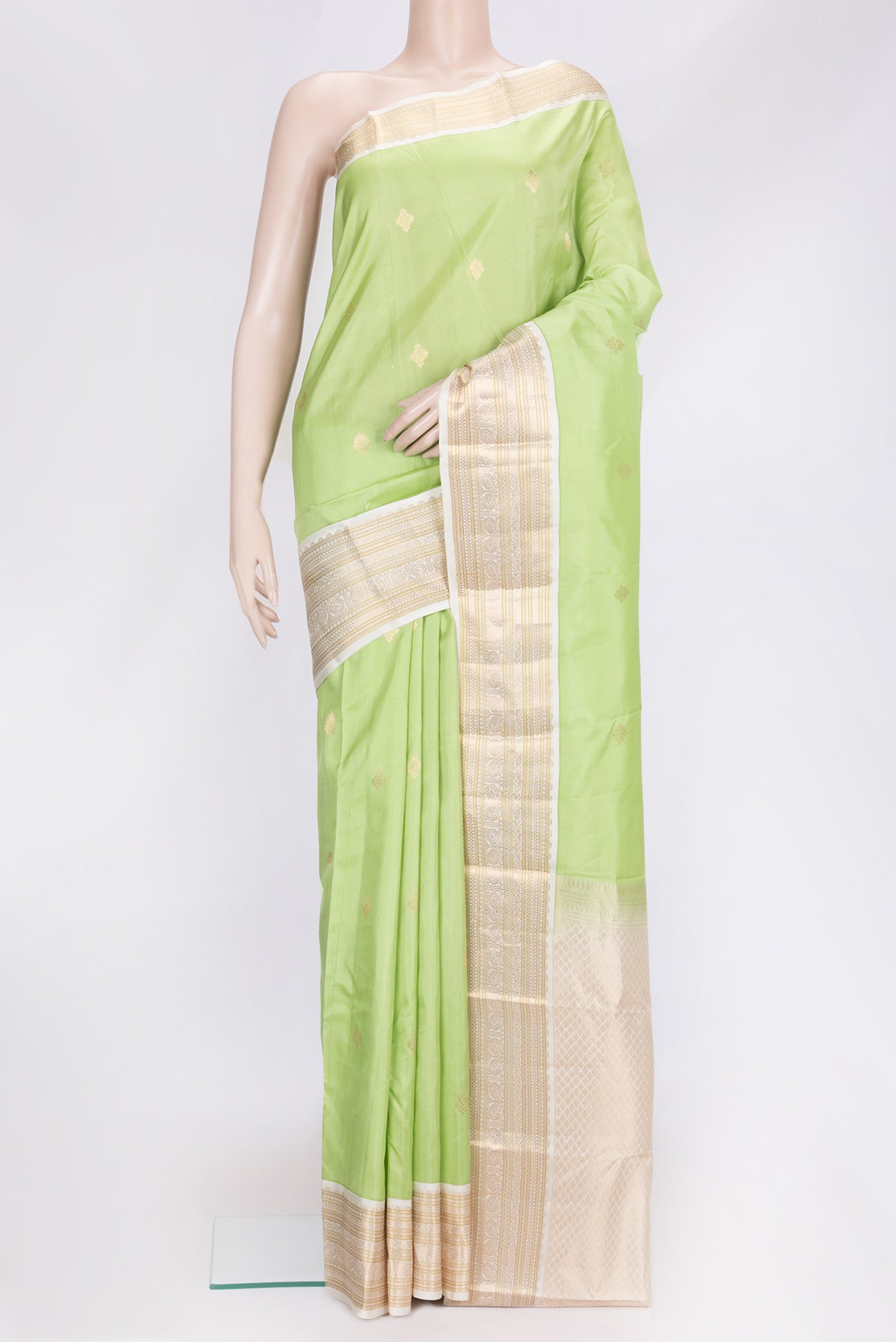 Pista Green Dual Tone Kanchipuram Silk Saree with Zari Butta on the body and Zari Border.  displayed on a mannequin
