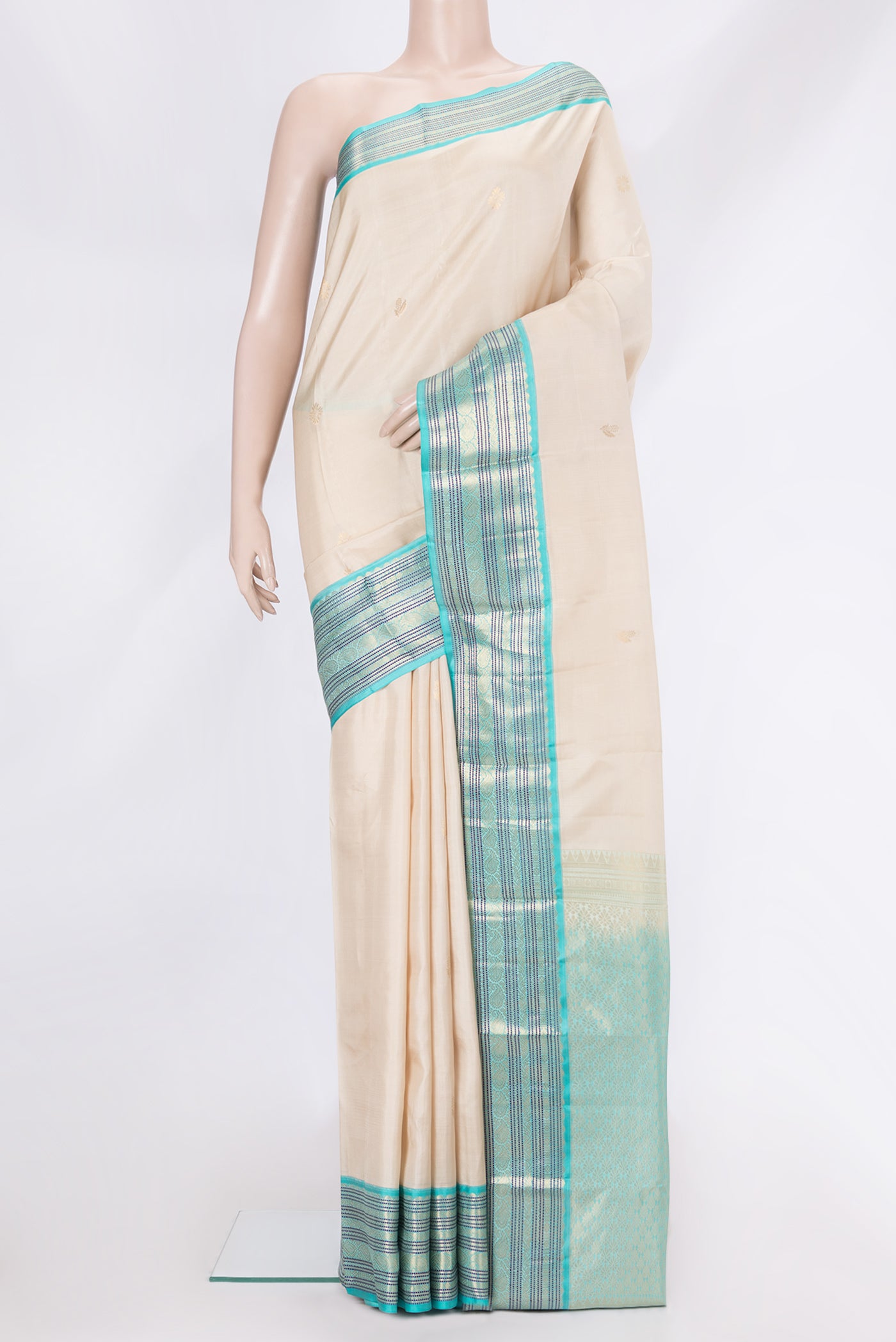 Beige Dual Tone Kanchipuram Silk Saree with Zari Butta on the body and Zari And Thread Border.  displayed on a mannequin