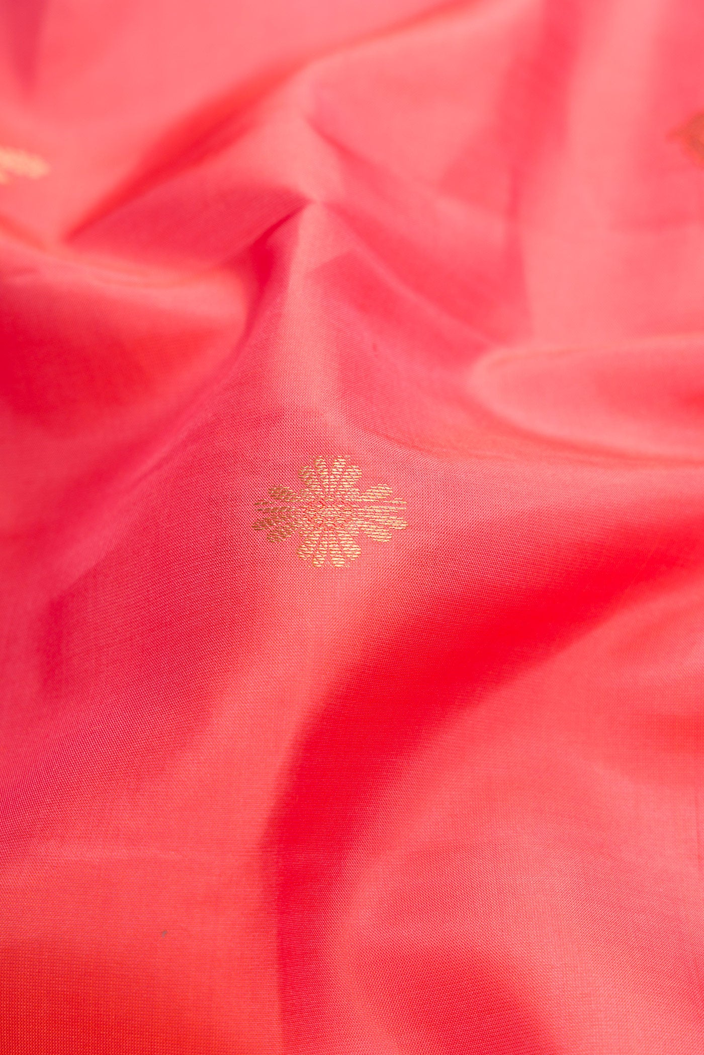 Close up of Pink Dual Tone Kanchipuram Silk Saree with Zari Butta on the body and Zari Border.  displaying folds