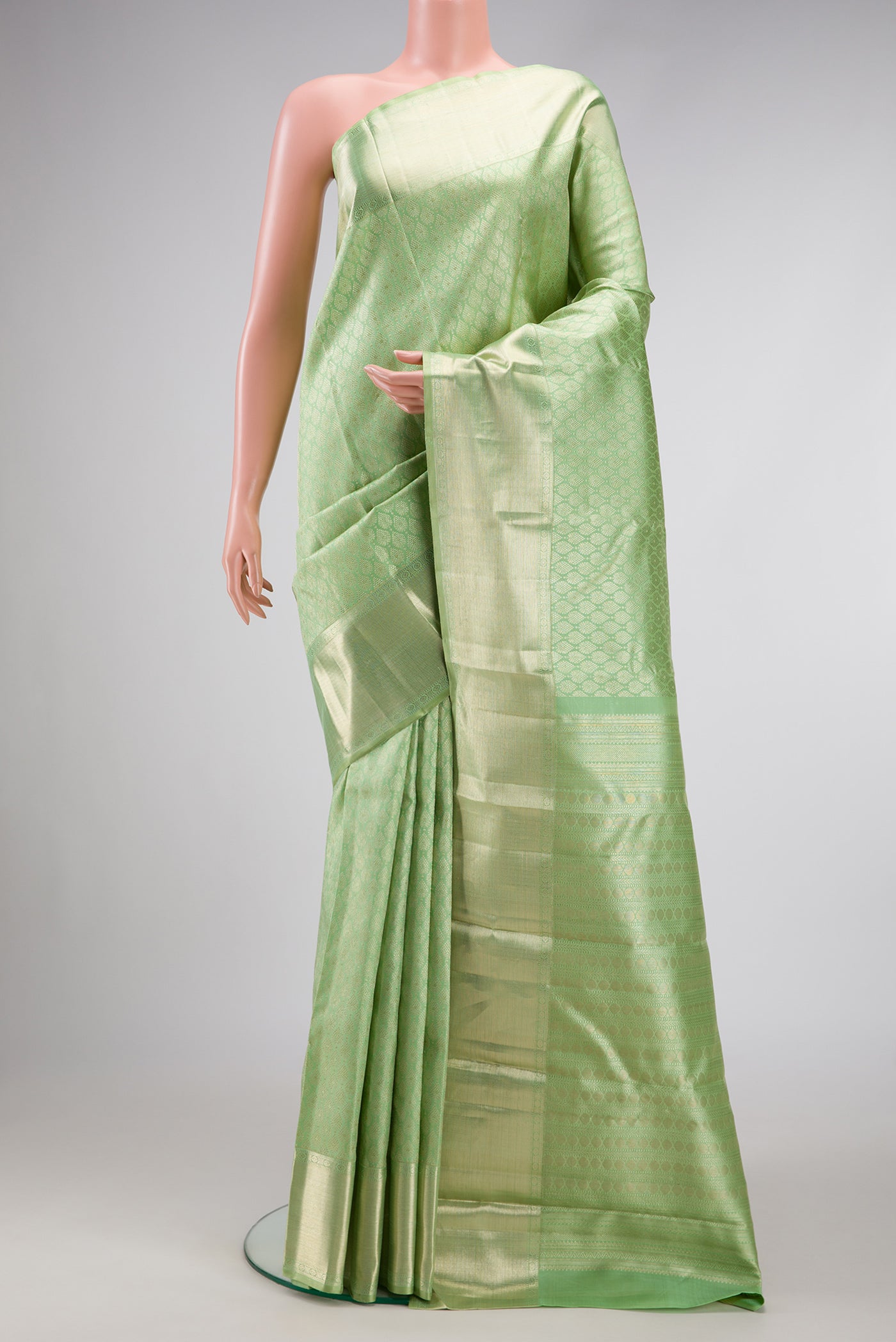 Pista Green Dual Tone Kanchipuram Silk Saree with Zari Brocade on the body and Zari Border.  displayed on a mannequin