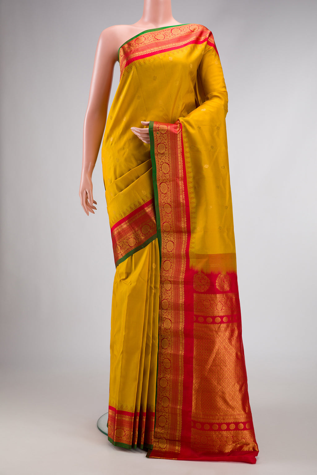 Mustard Dual Tone Gadwal Silk Saree with Zari Butta on the body and Zari Border.  displayed on a mannequin