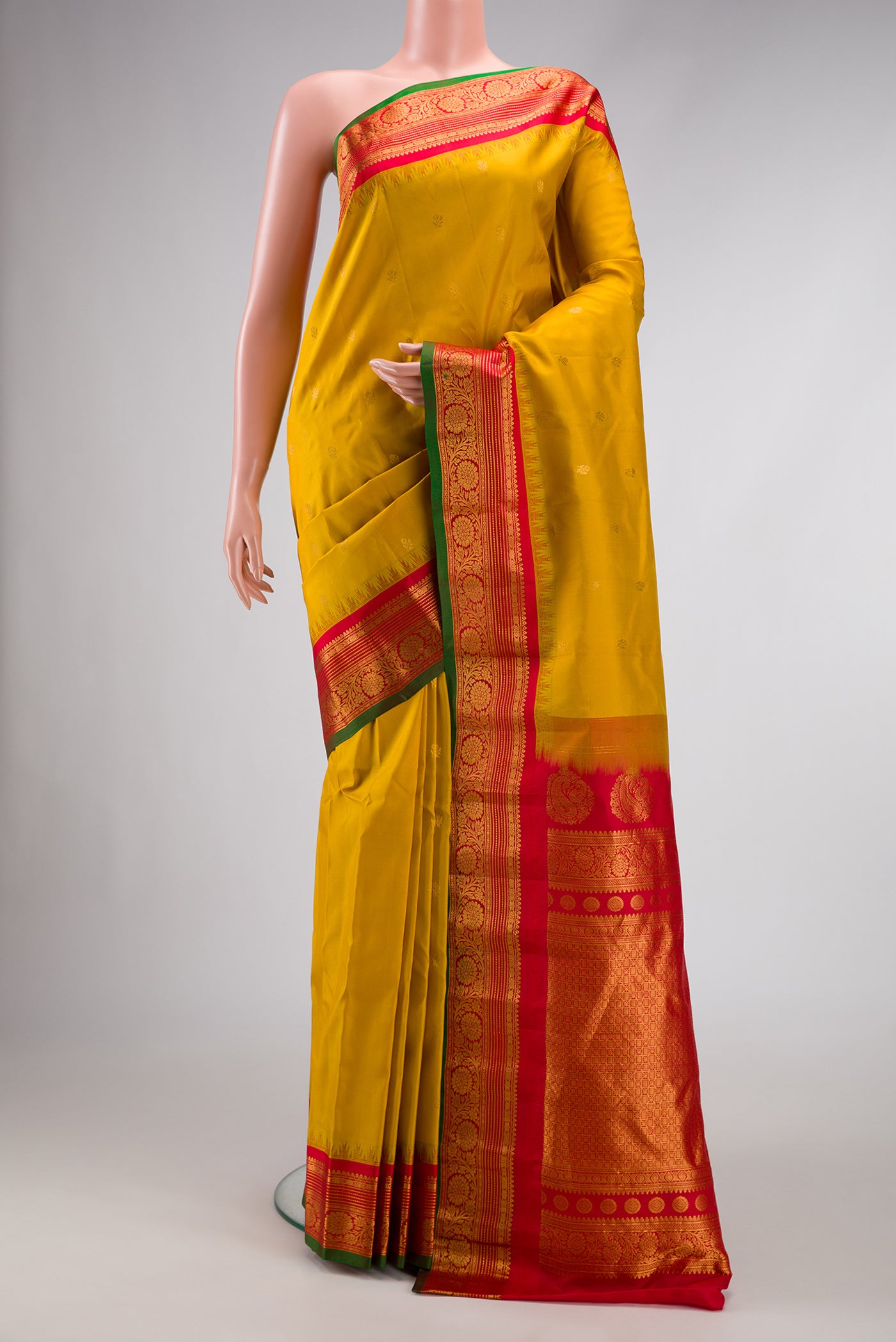 Mustard Dual Tone Gadwal Silk Saree with Zari Butta on the body and Zari Border.  displayed on a mannequin