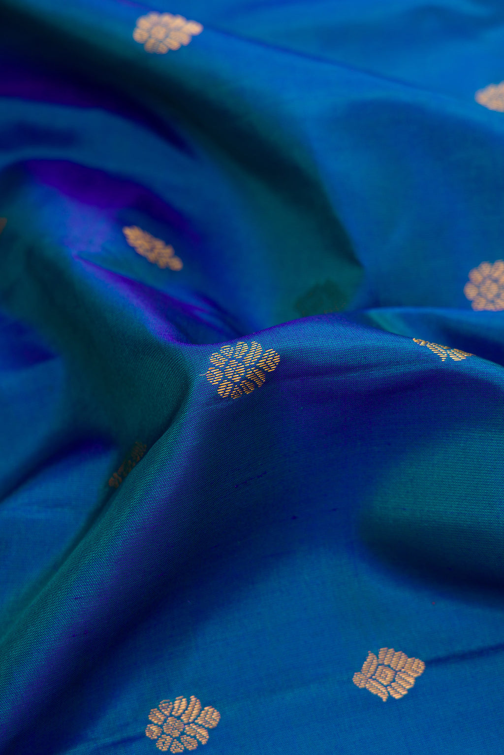 Close up of Sky Blue Dual Tone Gadwal Silk Saree with Zari Butta on the body and Zari Border.  displaying folds