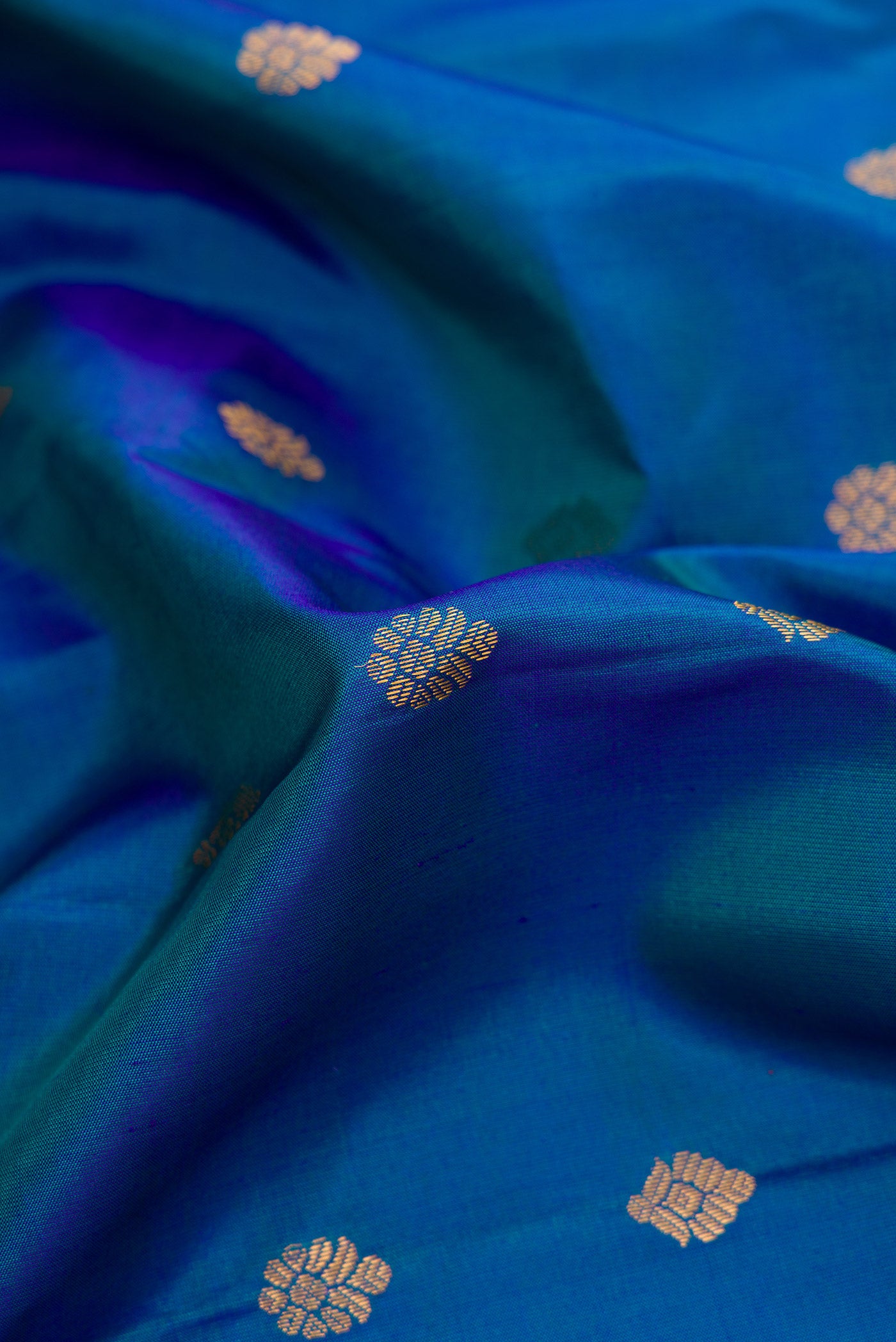 Close up of Sky Blue Dual Tone Gadwal Silk Saree with Zari Butta on the body and Zari Border.  displaying folds