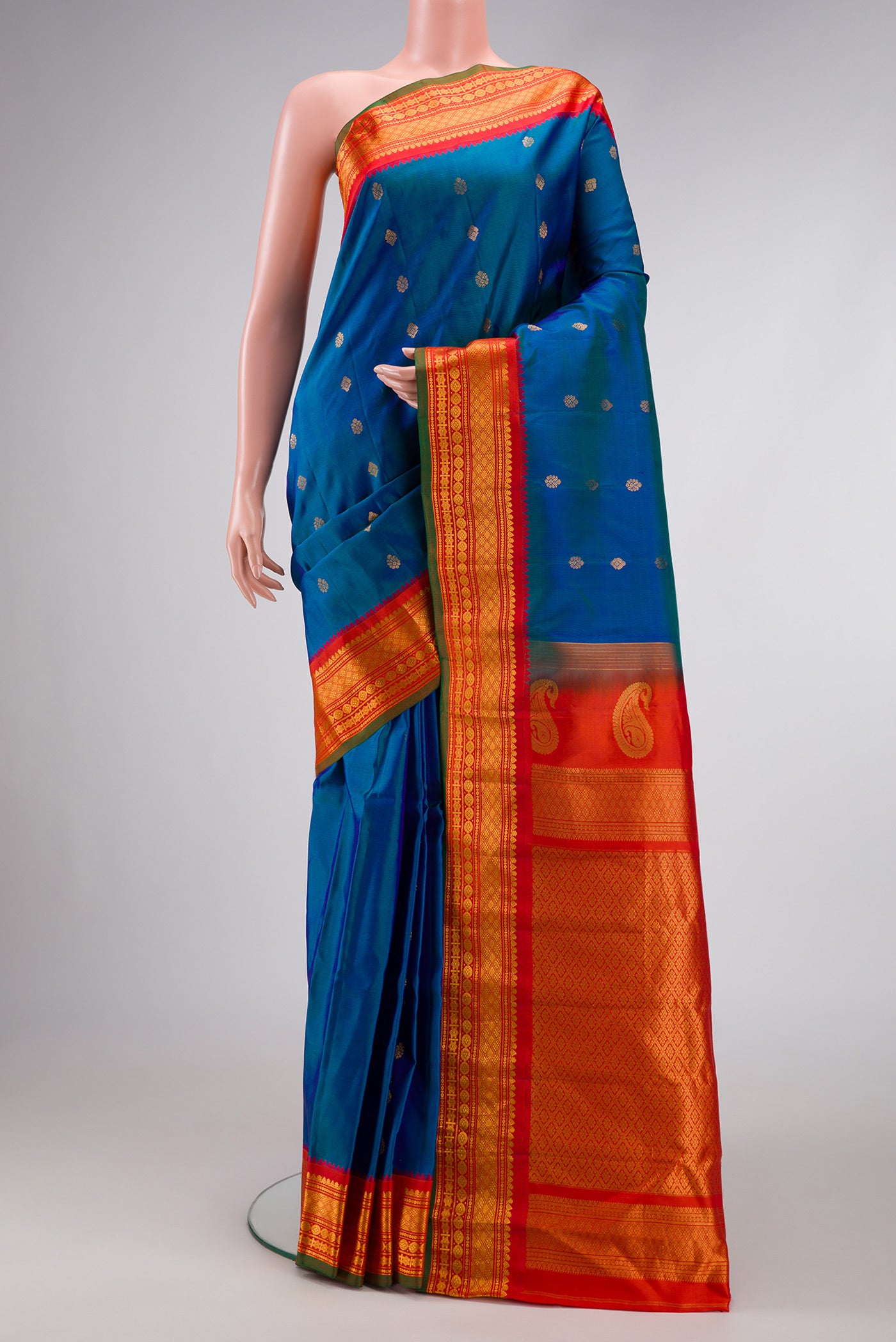 Sky Blue Dual Tone Gadwal Silk Saree with Zari Butta on the body and Zari Border.  displayed on a mannequin