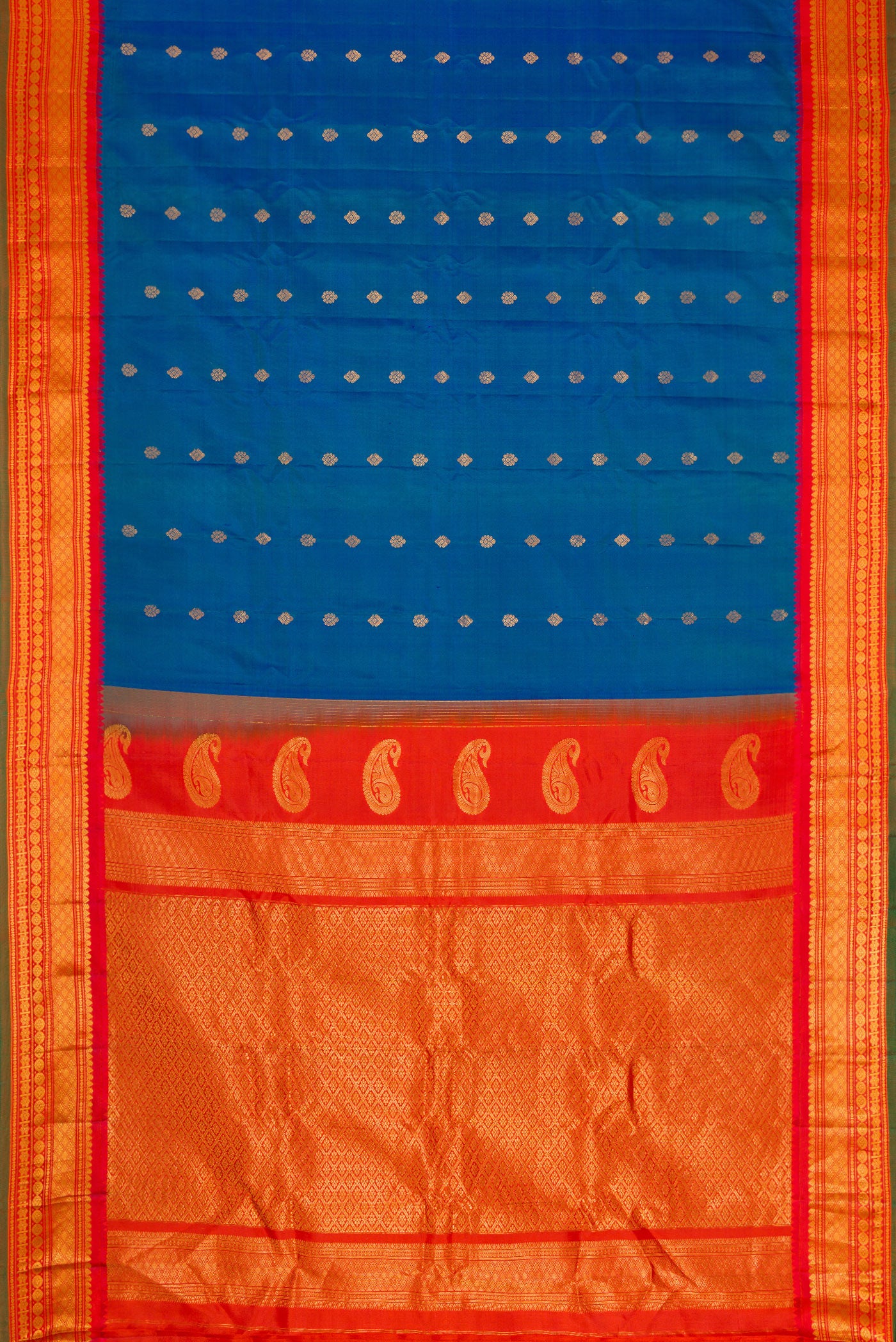 Flat view of Sky Blue Dual Tone Gadwal Silk Saree with Zari Butta on the body and Zari Border. 