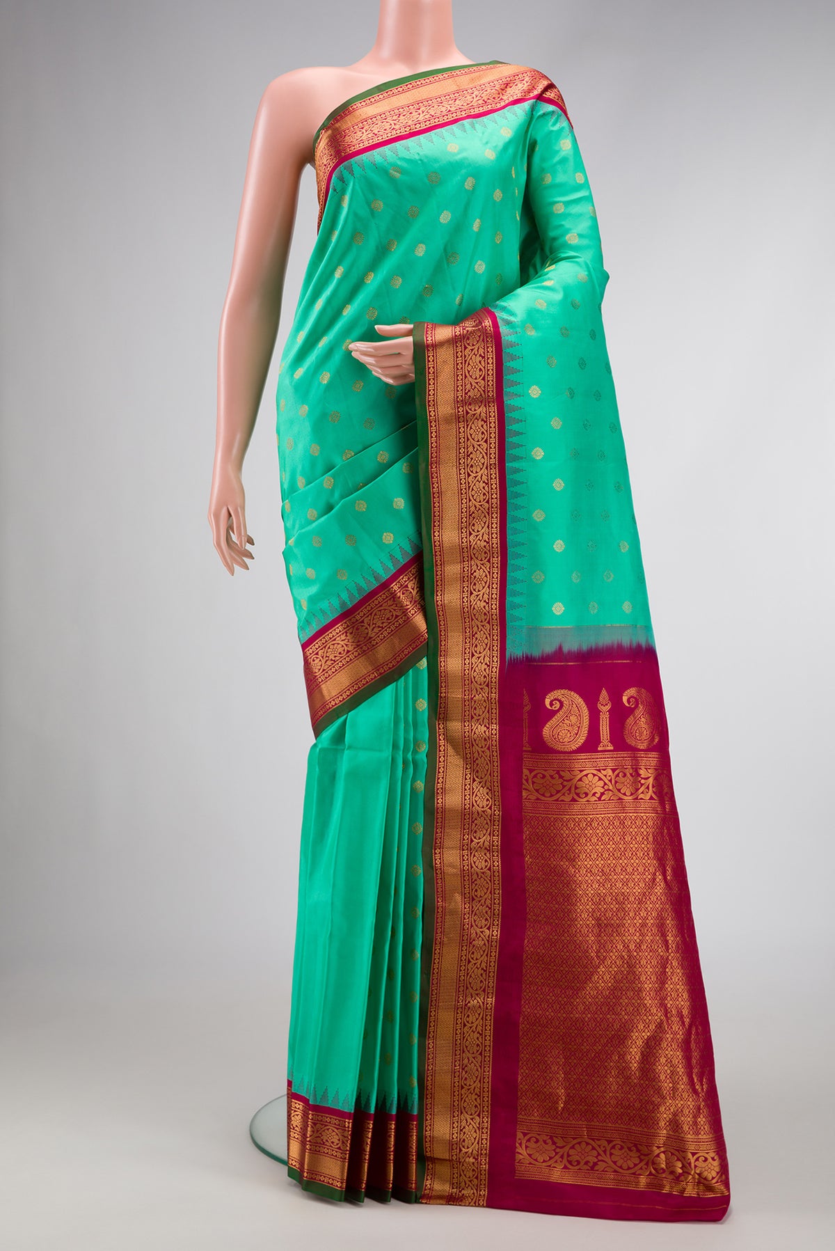 Sea Green Dual Tone Gadwal Silk Saree with Zari Butta on the body and Zari Border.  displayed on a mannequin