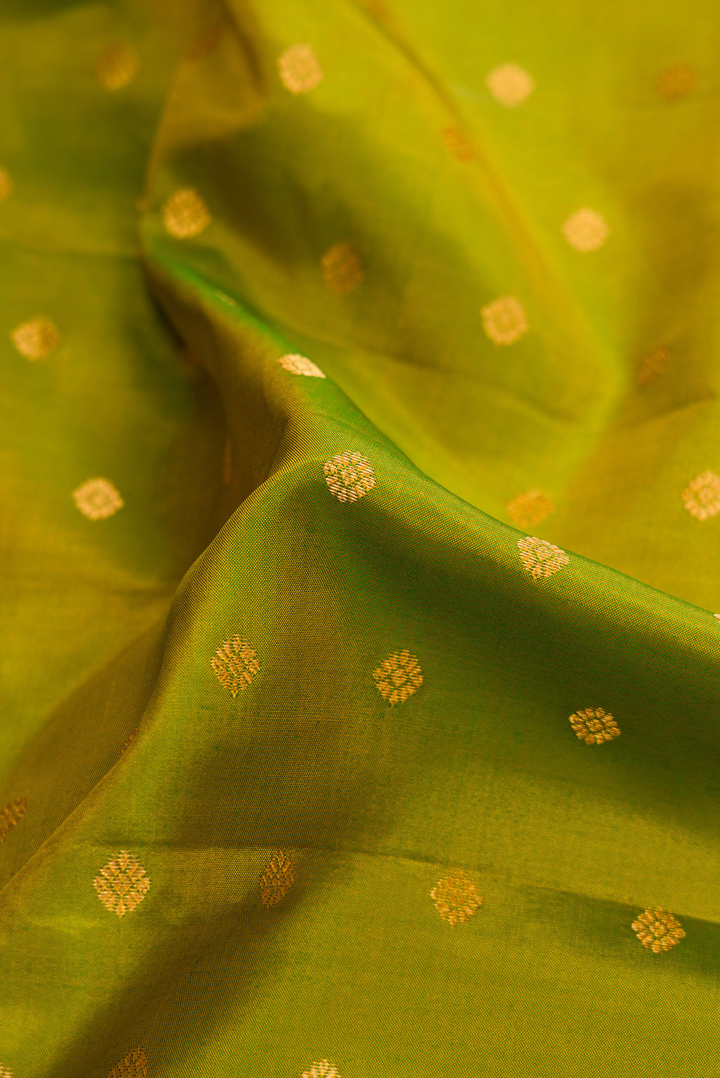 Close up of Mehandi Green Dual Tone Gadwal Silk Saree with Zari Butta on the body and Zari Border.  displaying folds
