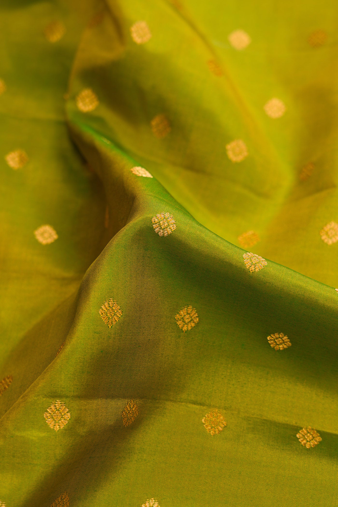 Close up of Mehandi Green Dual Tone Gadwal Silk Saree with Zari Butta on the body and Zari Border.  displaying folds