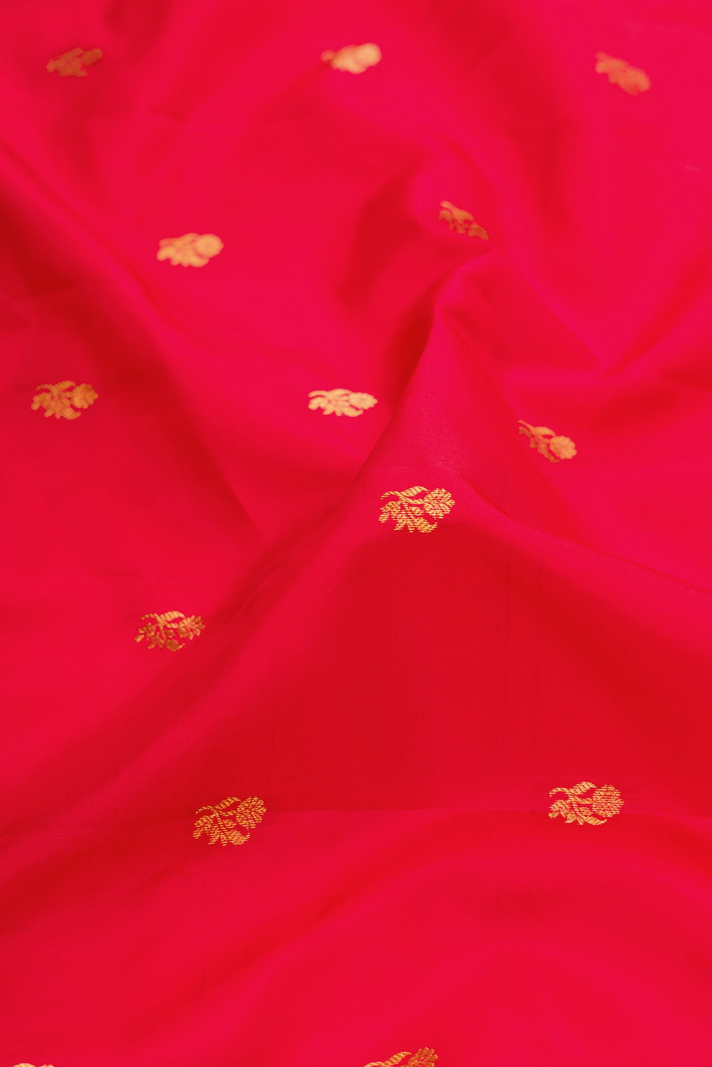 Close up of Red Dual Tone Gadwal Silk Saree with Zari Butta on the body and Zari Border.  displaying folds