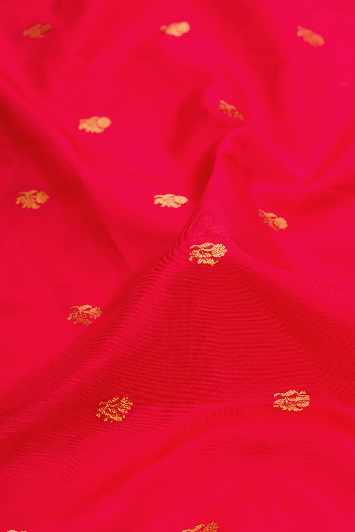 Close up of Red Dual Tone Gadwal Silk Saree with Zari Butta on the body and Zari Border.  displaying folds