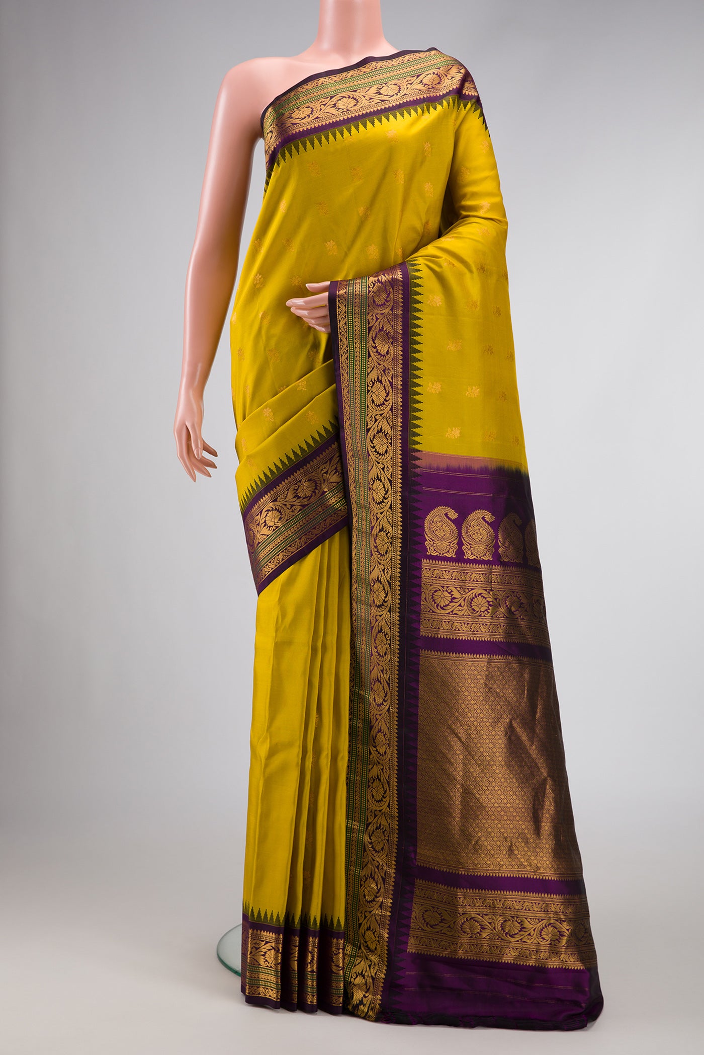 Mehandi Green Dual Tone Gadwal Silk Saree with Zari Butta on the body and Zari Border.  displayed on a mannequin
