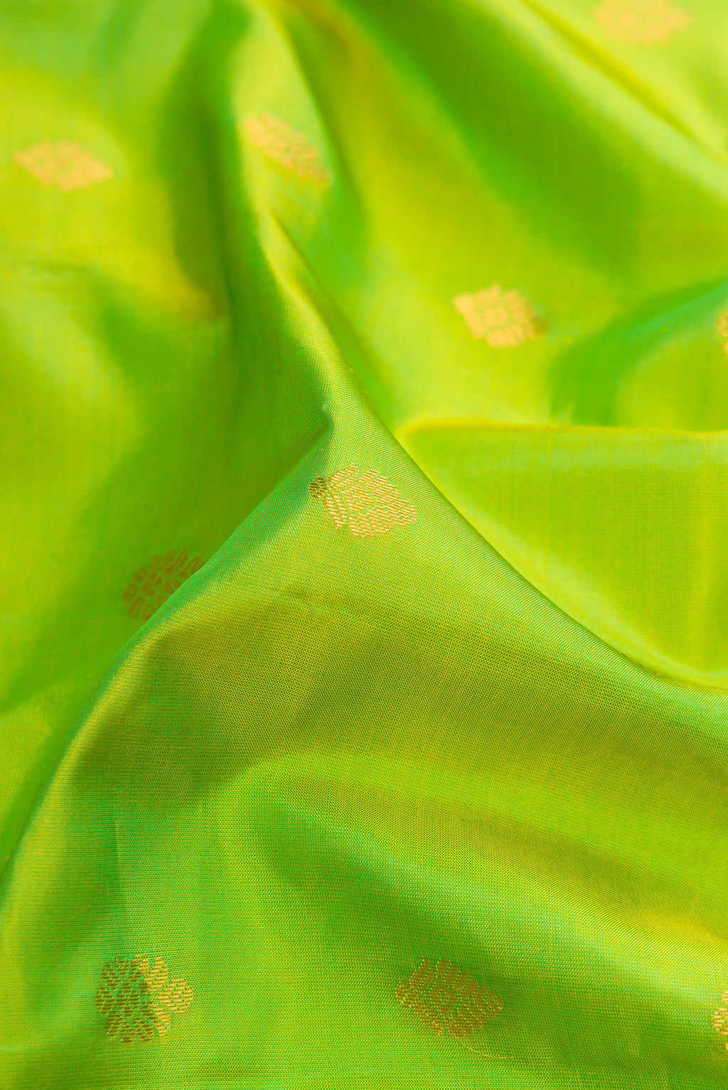 Close up of Parrot Green Dual Tone Gadwal Silk Saree with Zari Butta on the body and Zari Border.  displaying folds