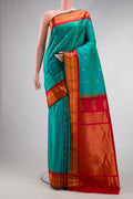 Green Dual Tone Gadwal Silk Saree with Zari Butta on the body and Zari Border.  displayed on a mannequin