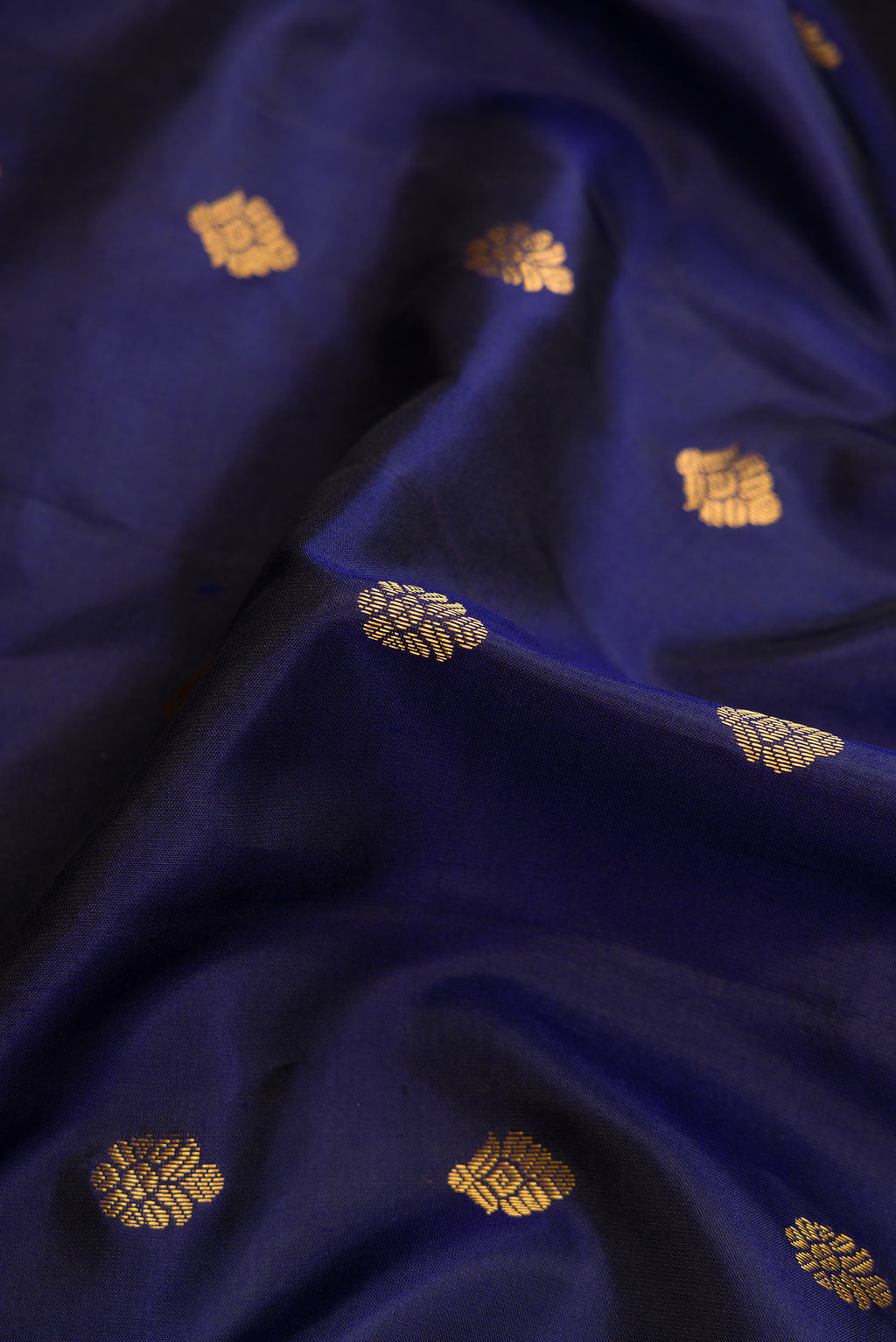 Close up of Navy Blue Dual Tone Gadwal Silk Saree with Zari Butta on the body and Zari Border.  displaying folds