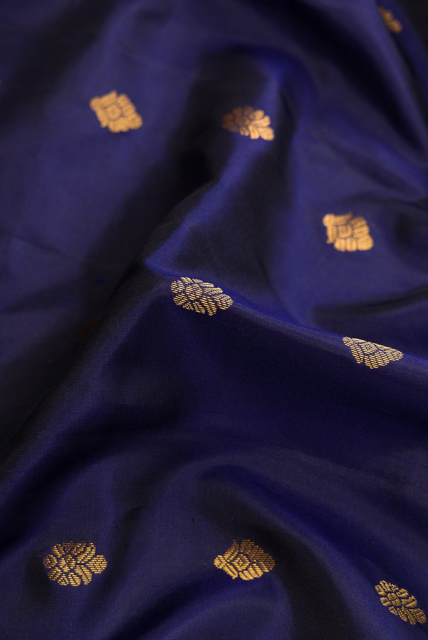 Close up of Navy Blue Dual Tone Gadwal Silk Saree with Zari Butta on the body and Zari Border.  displaying folds