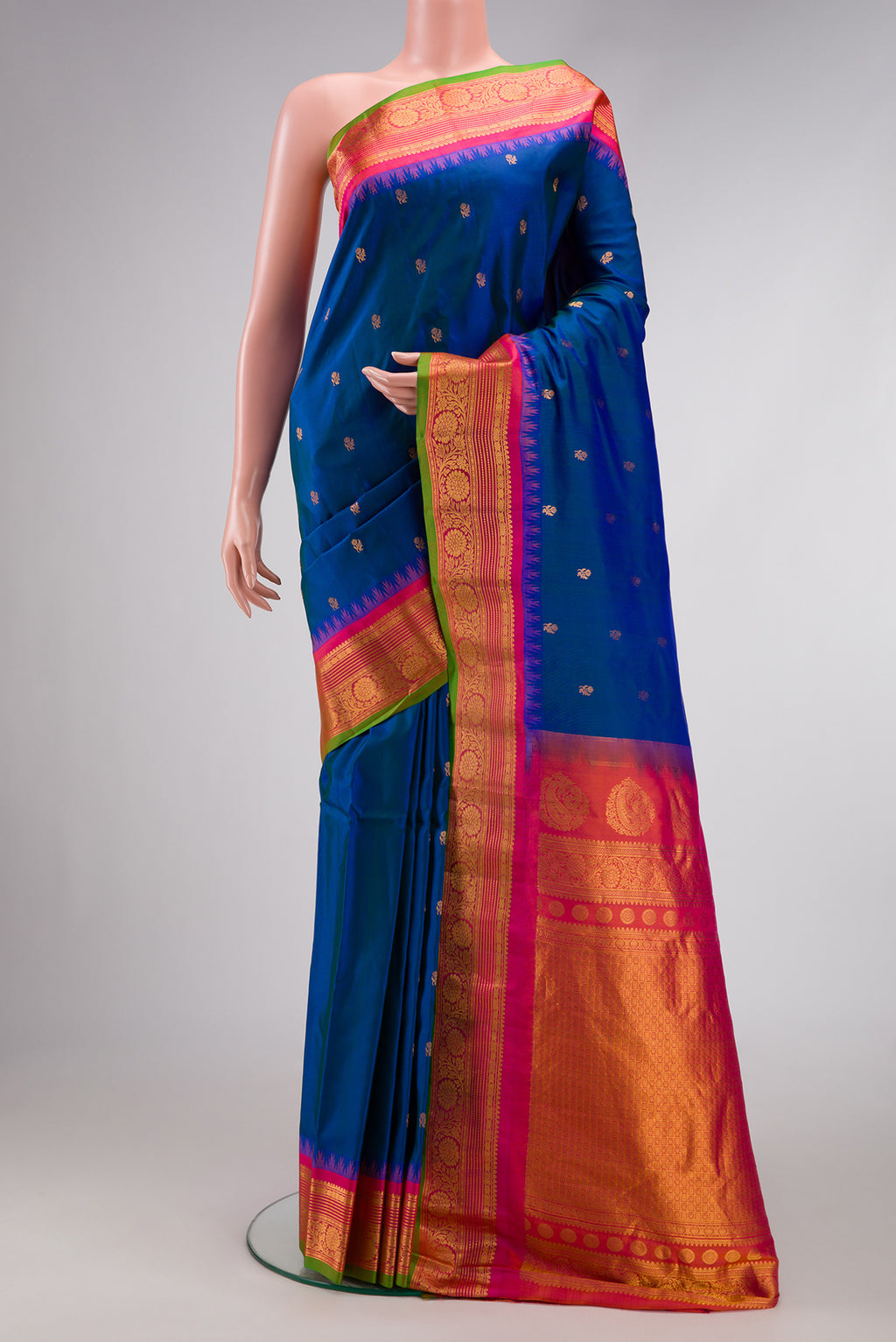 Peacock Blue Dual Tone Gadwal Silk Saree with Zari Butta on the body and Temple Border.  displayed on a mannequin